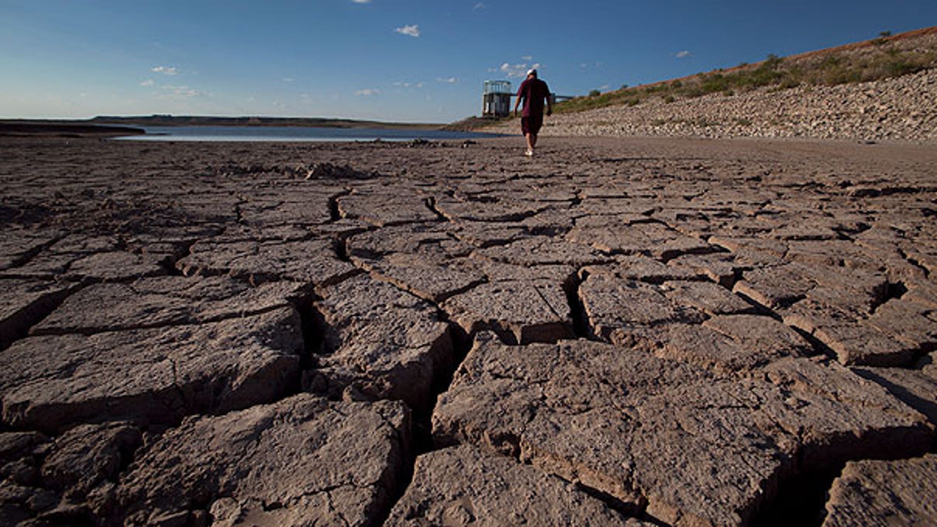 Aug. 7: Eddie Ray Roberts, superintendent of the city's waste and water department walks on the dried bed of Lake E.V. Spence in Robert Lee, Texas. After years of diminishing water supplies made even worse by the second most severe drought in state history, some communities are resorting to a plan that might have seemed absurd a generation ago: turning sewage into drinking water.