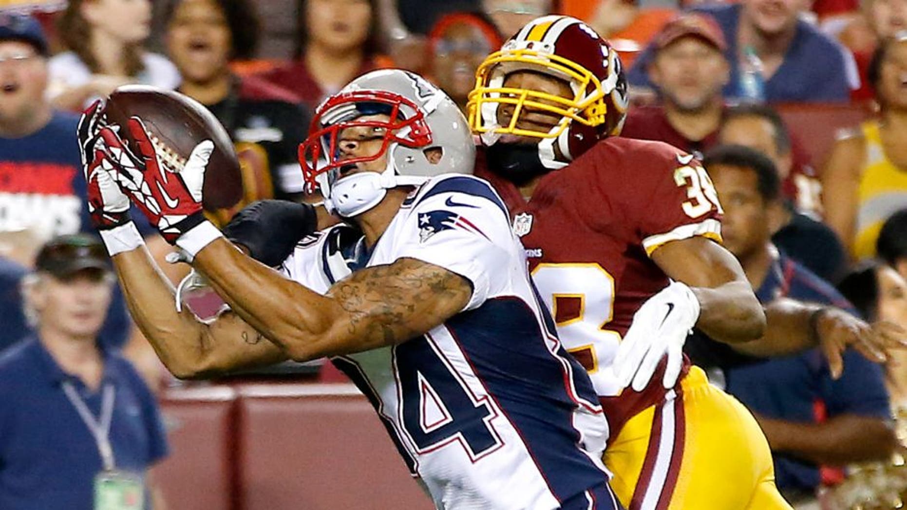 Aug 7, 2014; Landover, MD, USA; New England Patriots wide receiver Brian Tyms attempts to catch the ball as Washington Redskins defensive back Chase Minnifield (38) defends in the third quarter during a preseason game at FedEx Field. The Redskins won 23-6. Mandatory Credit: Geoff Burke-USA TODAY Sports