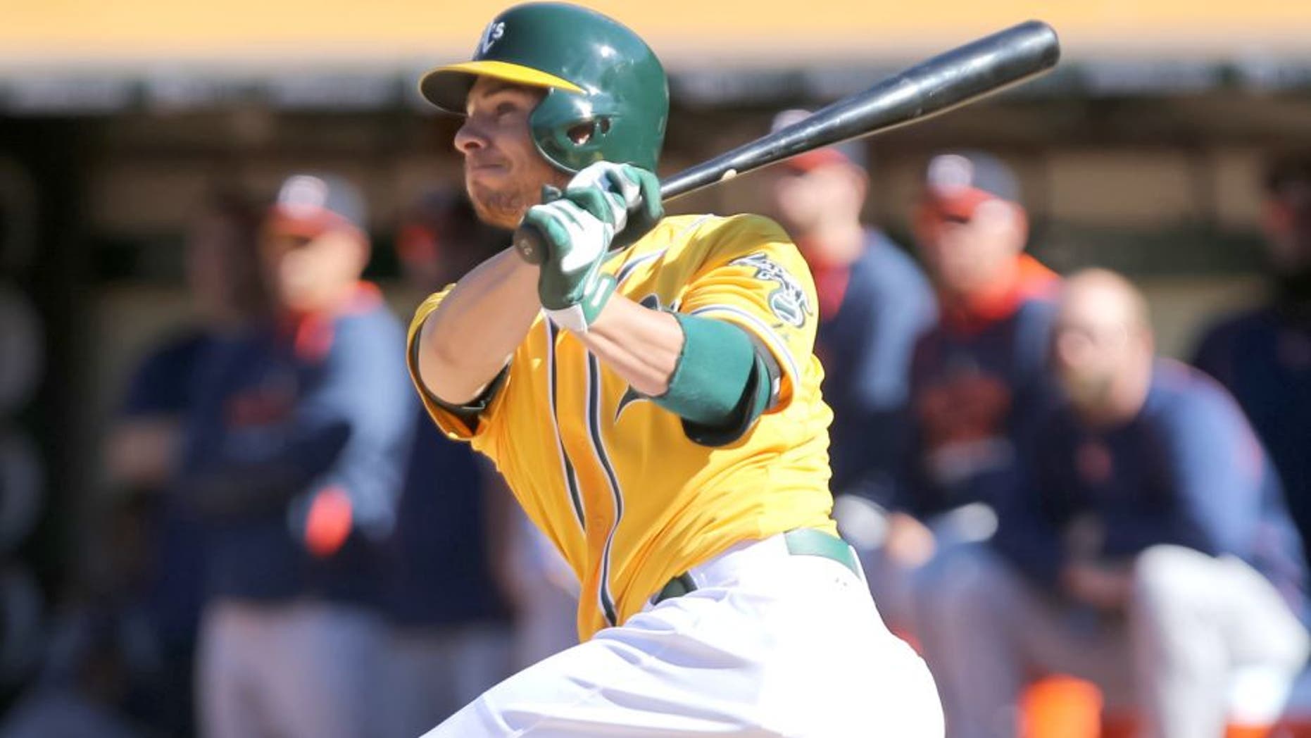 Aug 9, 2015; Oakland, CA, USA; Oakland Athletics third baseman Danny Valencia (26) hits an RBI single against the Houston Astros during the ninth inning for a walk-off win at O.co Coliseum. The Athletics won 5-4. Mandatory Credit: Kelley L Cox-USA TODAY Sports