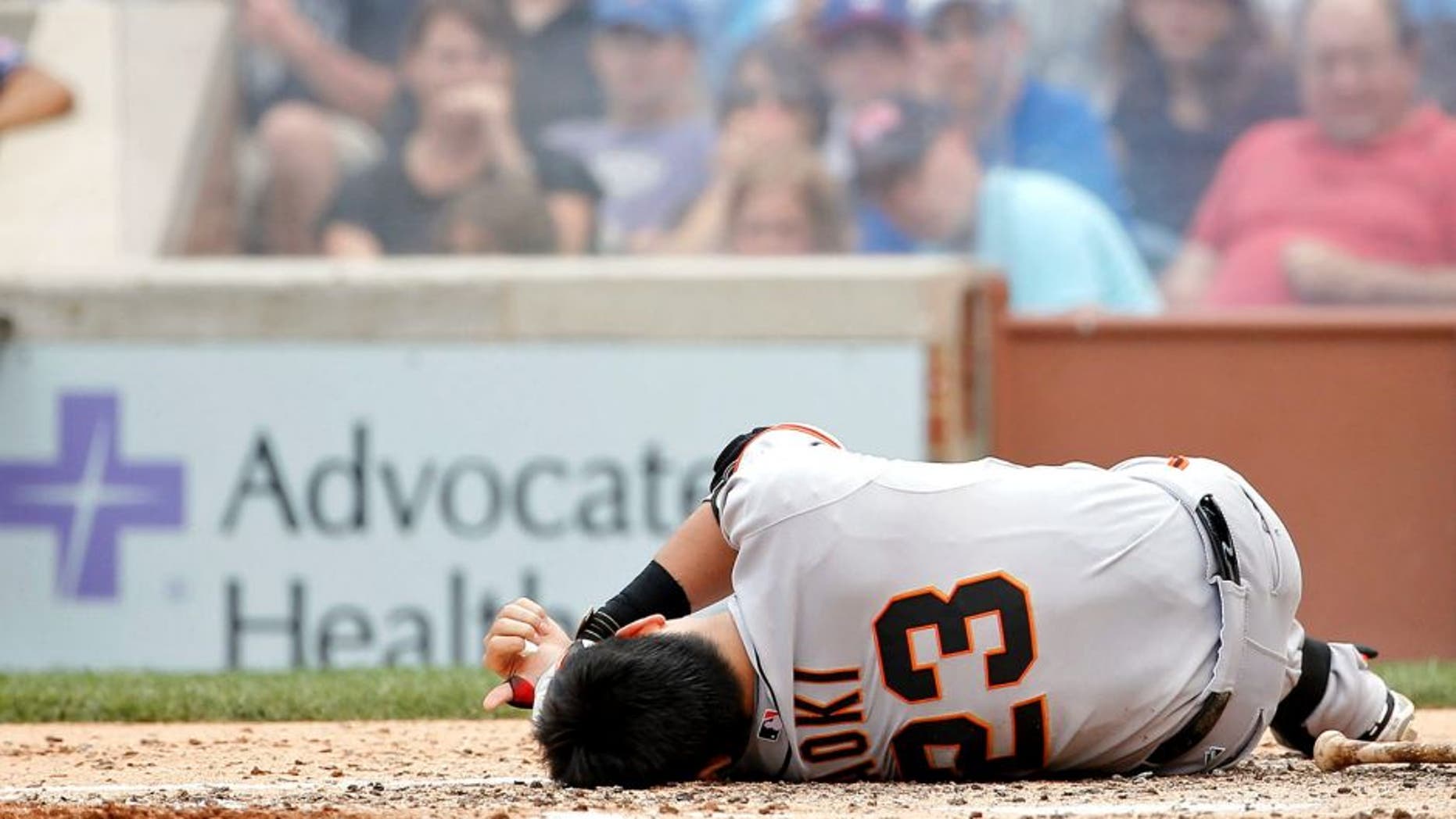 CHICAGO, IL - AUGUST 09: Nori Aoki #23 of the San Francisco Giants reacts after being hit in the head by a pitch thrown by Jake Arrieta #49 of the Chicago Cubs (not pictured) at Wrigley Field on August 9, 2015 in Chicago, Illinois. (Photo by Jon Durr/Getty Images)