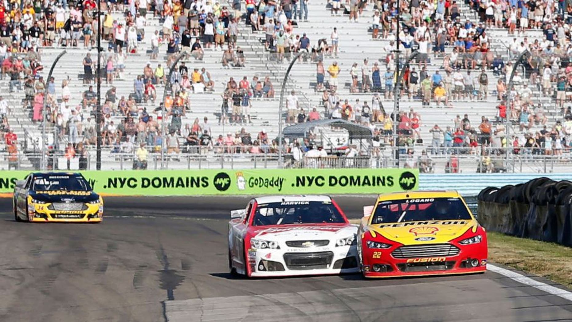 Aug 9, 2015; Watkins Glen, NY, USA; Sprint Cup Series driver Joey Logano (22) passes driver Kevin Harvick (4) on the final turn of the final lap to win the the Cheez-It 355 at Watkins Glen International. Mandatory Credit: Kevin Hoffman-USA TODAY Sports