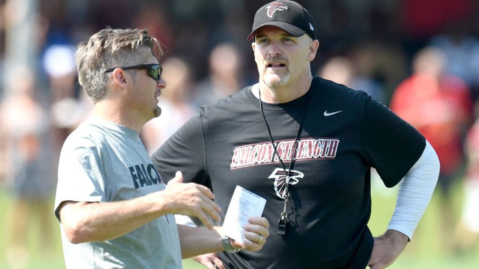 Jul 31, 2015; Flowery Branch, GA, USA; Atlanta Falcons head coach Dan Quinn (right) talks to General Manager Thomas Dimitroff on the field during training camp at Flowery Branch Training Facility. Mandatory Credit: Dale Zanine-USA TODAY Sports