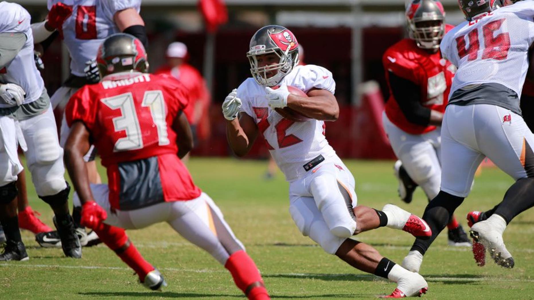 Aug 6, 2015; Tampa Bay, FL, USA; Tampa Bay Buccaneers running back Doug Martin (22) runs with the ball as Tampa Bay Buccaneers strong safety Major Wright (31) defends works out during training camp at One Buc Place. Mandatory Credit: Kim Klement-USA TODAY Sports
