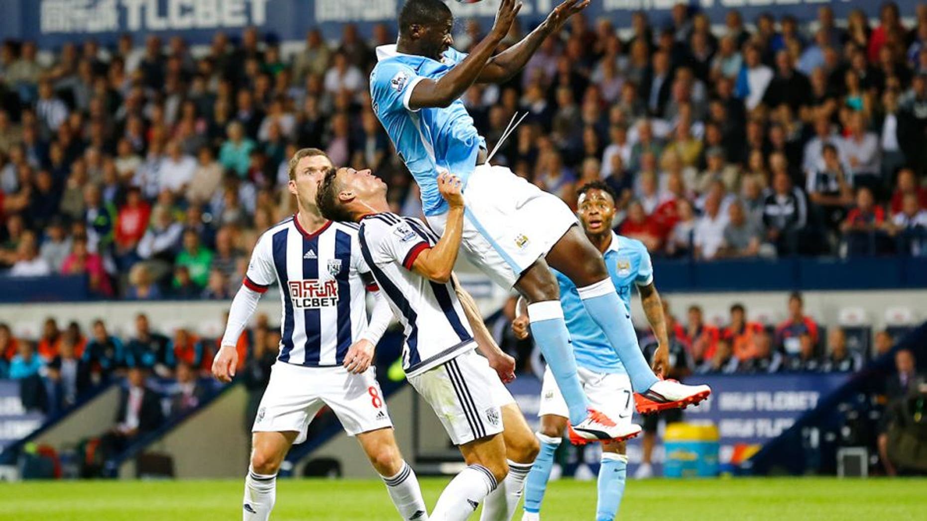 Football - West Bromwich Albion v Manchester City - Barclays Premier League - The Hawthorns - 10/8/15 Manchester City's Yaya Toure in action with West Brom's James Chester Reuters / Darren Staples Livepic EDITORIAL USE ONLY. No use with unauthorized audio, video, data, fixture lists, club/league logos or "live" services. Online in-match use limited to 45 images, no video emulation. No use in betting, games or single club/league/player publications. Please contact your account representative for further details.