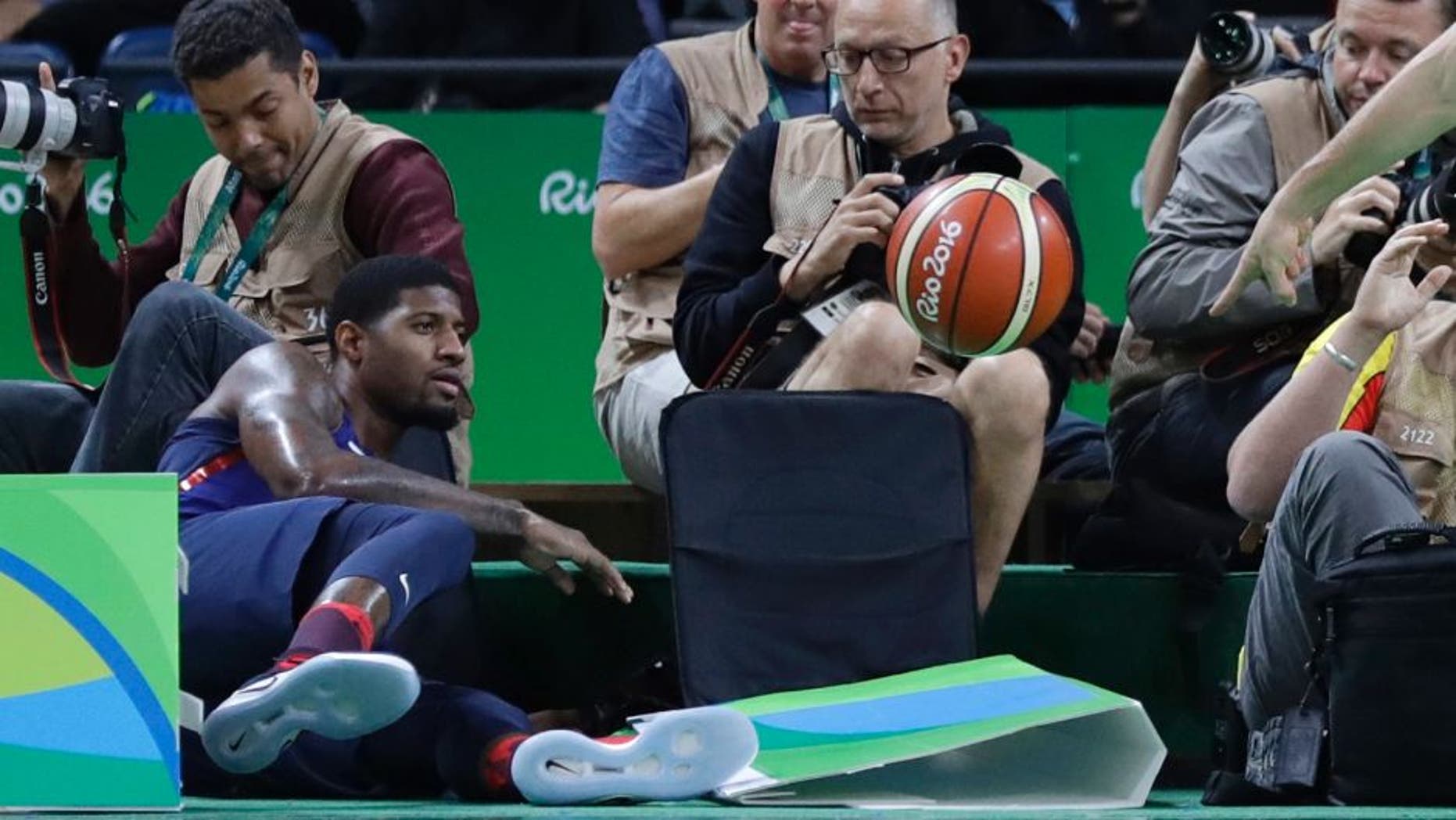 United States' Paul George, left, chases a loose ball out of bounds during a men's basketball game against Australia at the 2016 Summer Olympics in Rio de Janeiro, Brazil, Wednesday, Aug. 10, 2016. (AP Photo/Eric Gay)