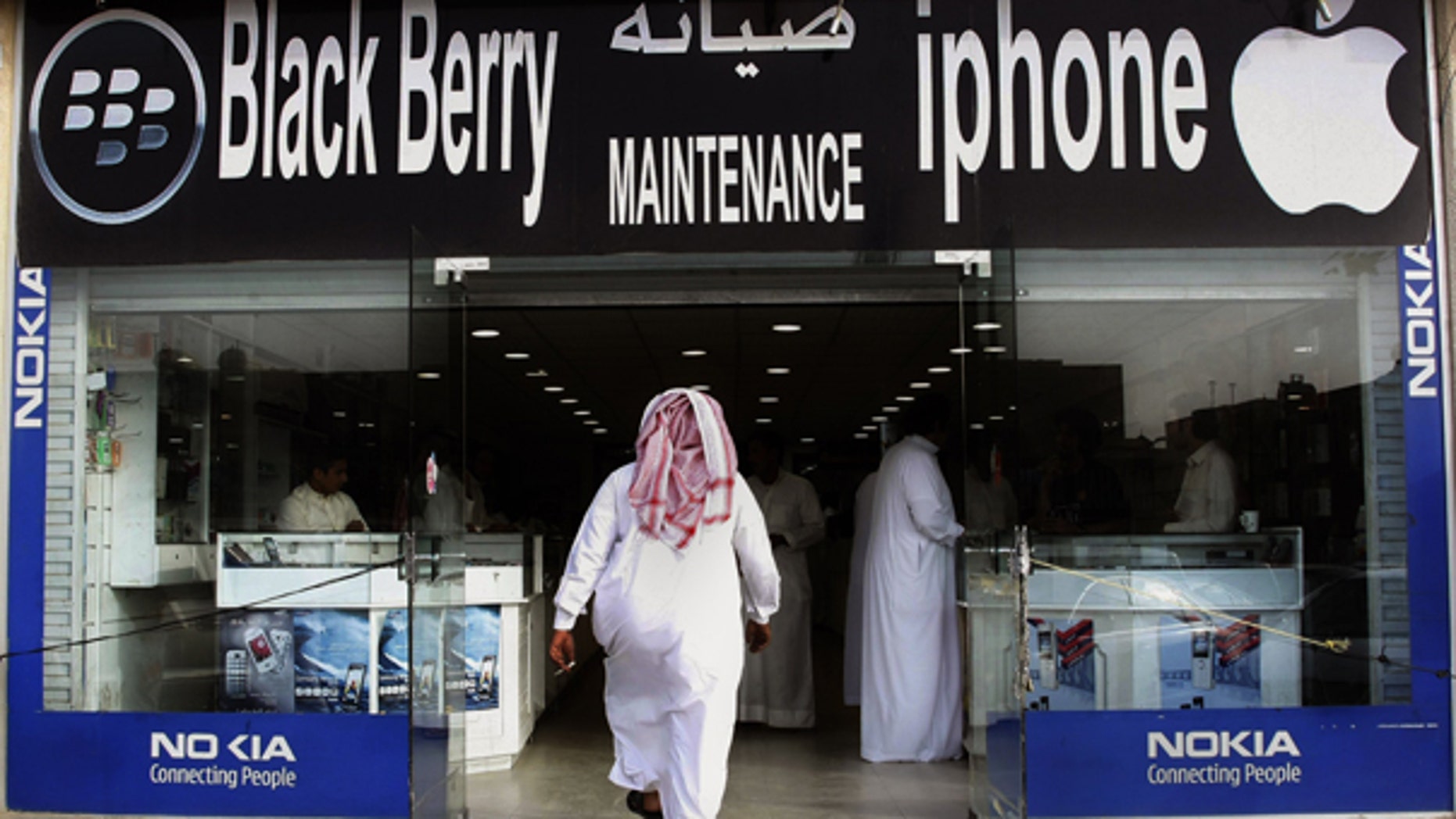 Aug. 5: A Saudi man enters a mobile shop at a market in the capital Riyadh, Saudi Arabia. Saudi and Emirati authorities' battle with BlackBerry manufacturer Research in Motion shows how rapid changes in technology are sowing unease in countries where the unfettered flow of data is seen as a threat.
