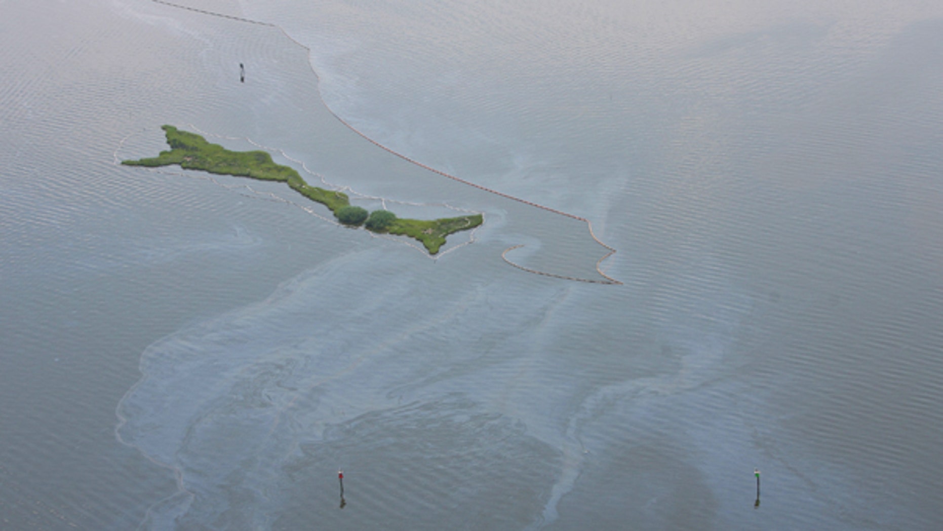Aug. 5: Oil from the Deepwater Horizon disaster is visible in Barataria Bay. BP finished pumping fresh cement into its blown-out oil well as aimed to seal for good the ruptured pipe that for months spewed crude into Gulf of Mexico in one of the world's worst spills.