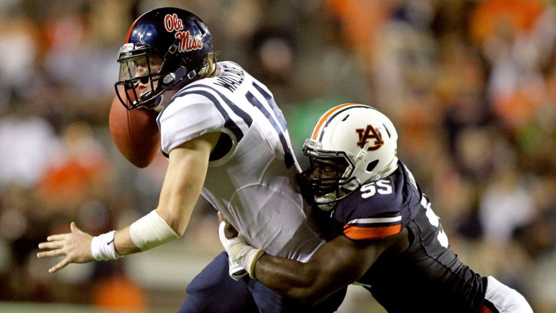 Oct 5, 2013; Auburn, AL, USA; Mississippi Rebels quarterback Bo Wallace (14) is tackled by Auburn Tigers defensive end Carl Lawson (55) during the first half at Jordan Hare Stadium. Mandatory Credit: John Reed-USA TODAY Sports