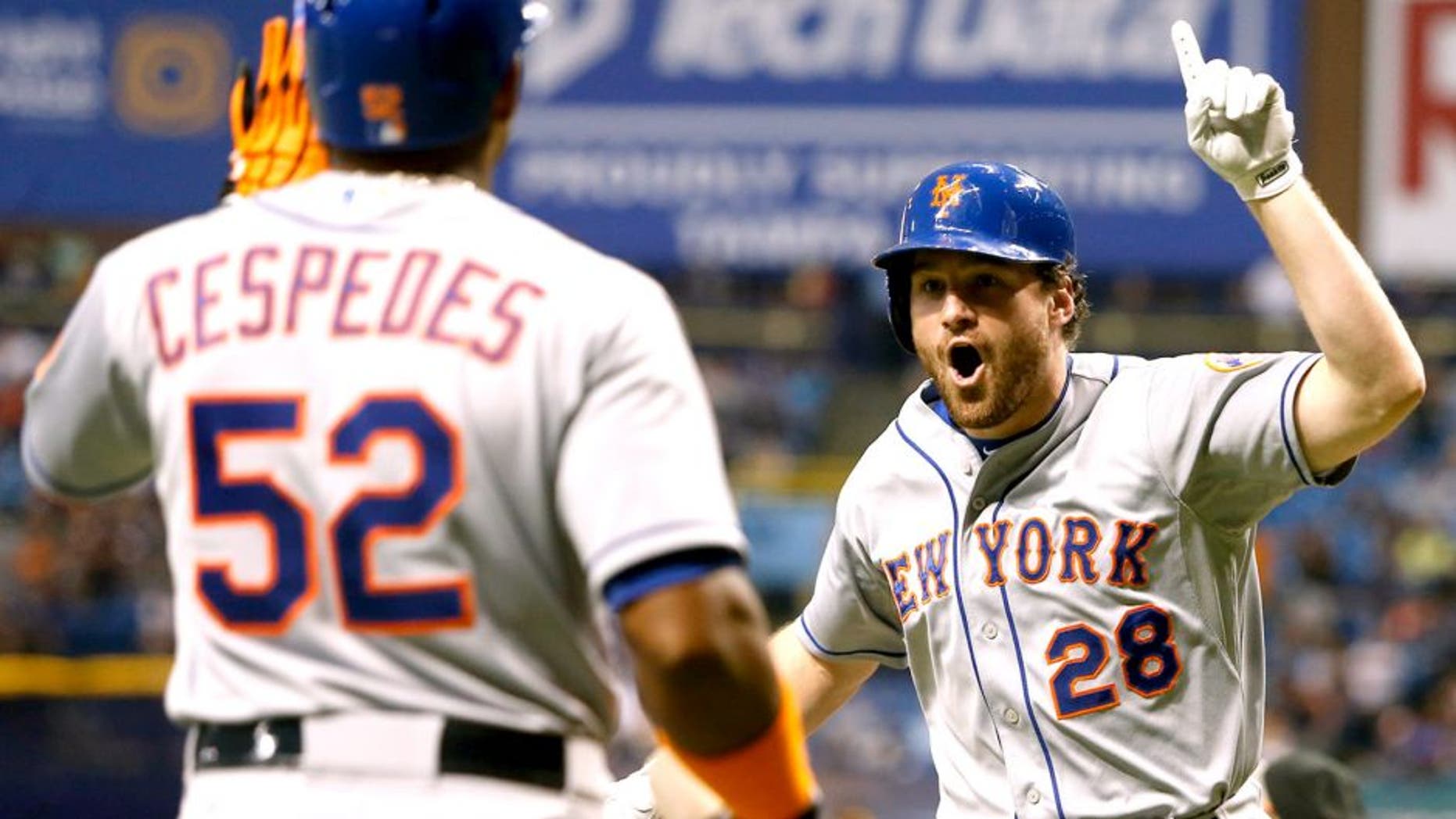 ST. PETERSBURG, FL - AUGUST 7: Daniel Murphy #28 of the New York Mets celebrates his home run with teammate Yoenis Cespedes #52 during the eighth inning of a game against the Tampa Bay Rays on August 7, 2015 at Tropicana Field in St. Petersburg, Florida. (Photo by Brian Blanco/Getty Images)