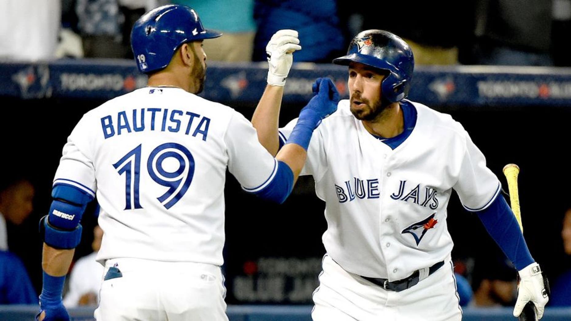 Aug 11, 2015; Toronto, Ontario, CAN; Toronto Blue Jays right fielder Jose Bautista (19) is greeted by designated hitter Chris Colabello (15) after hitting a home run against Oakland Athletics in the fifth inning at Rogers Centre. Mandatory Credit: Dan Hamilton-USA TODAY Sports