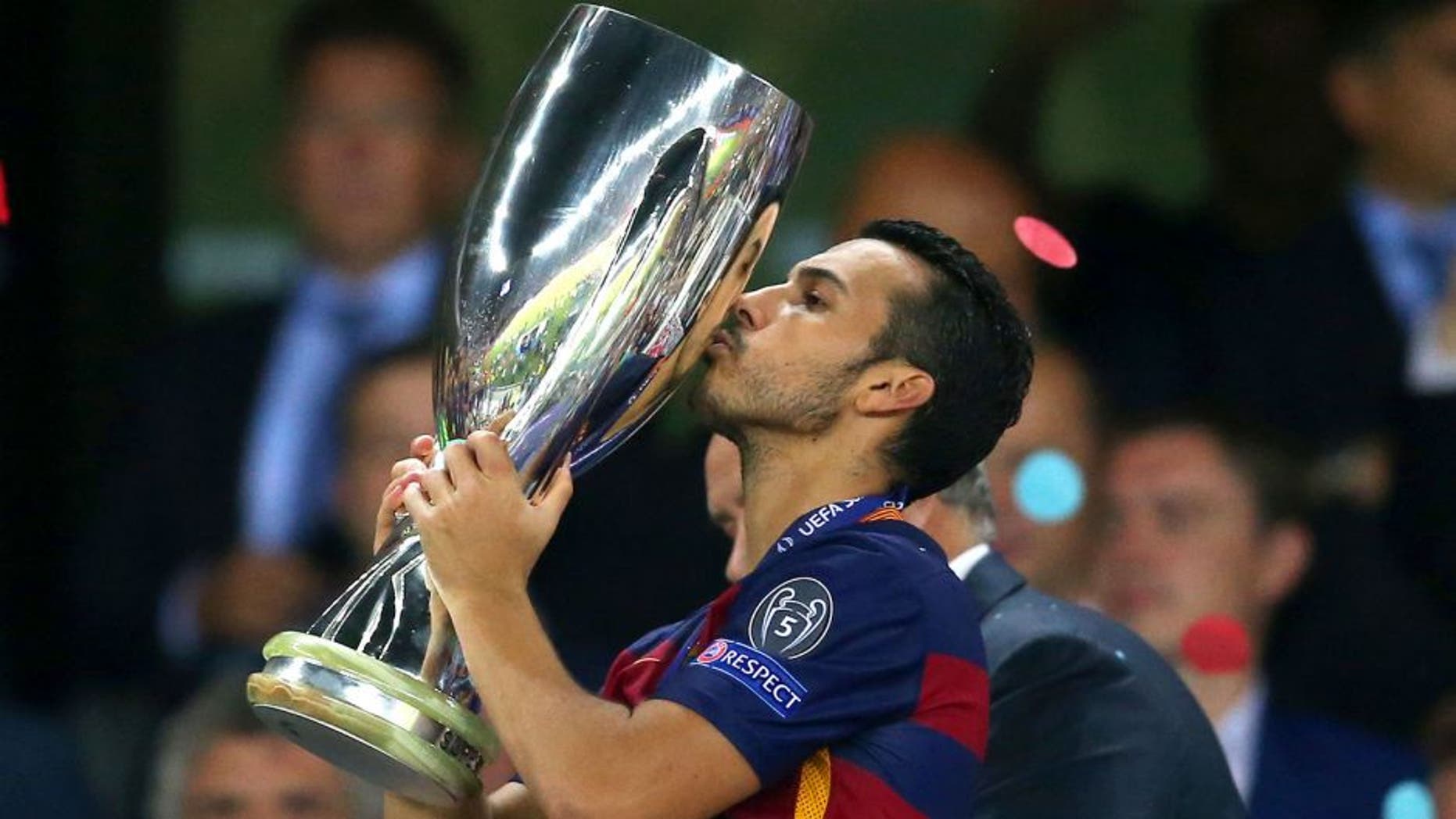 TBILISI, GEORGIA - AUGUST 11: Pedro of Barcelona kisses the UEFA Cup trophy as Barcelona celebrate victoy during the UEFA Super Cup between Barcelona and Sevilla FC at Dinamo Arena on August 11, 2015 in Tbilisi, Georgia. (Photo by Chris Brunskill/Getty Images)