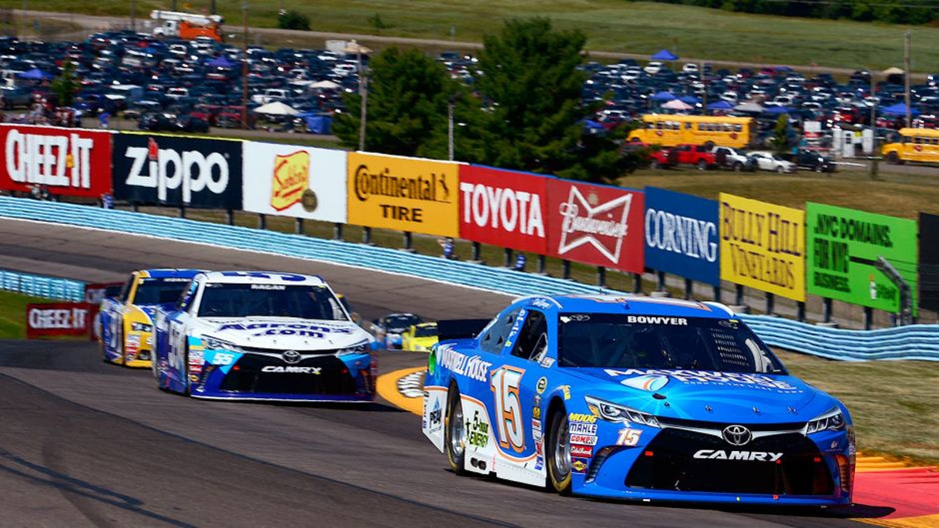 WATKINS GLEN, NY - AUGUST 09: Clint Bowyer, driver of the #15 Maxwell House Toyota, leads David Ragan, driver of the #55 Aaron's Dream Machine Online Version Toyota, ahead of a pack of cars during the NASCAR Sprint Cup Series Cheez-It 355 at the Glen at Watkins Glen International on August 9, 2015 in Watkins Glen, New York. (Photo by Robert Laberge/NASCAR via Getty Images)