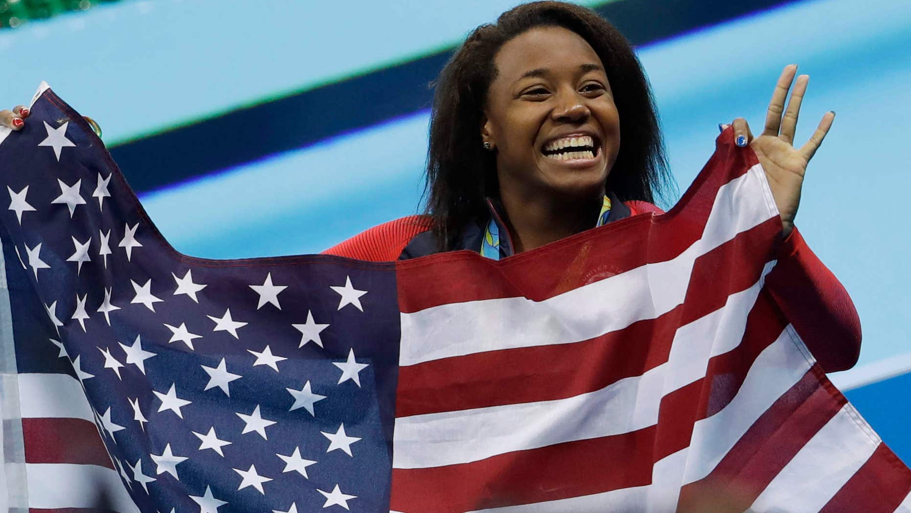 United States' Simone Manuel celebrates winning the gold medal in the women's 100-meter freestyle during the swimming competitions at the 2016 Summer Olympics, Friday, Aug. 12, 2016, in Rio de Janeiro, Brazil.