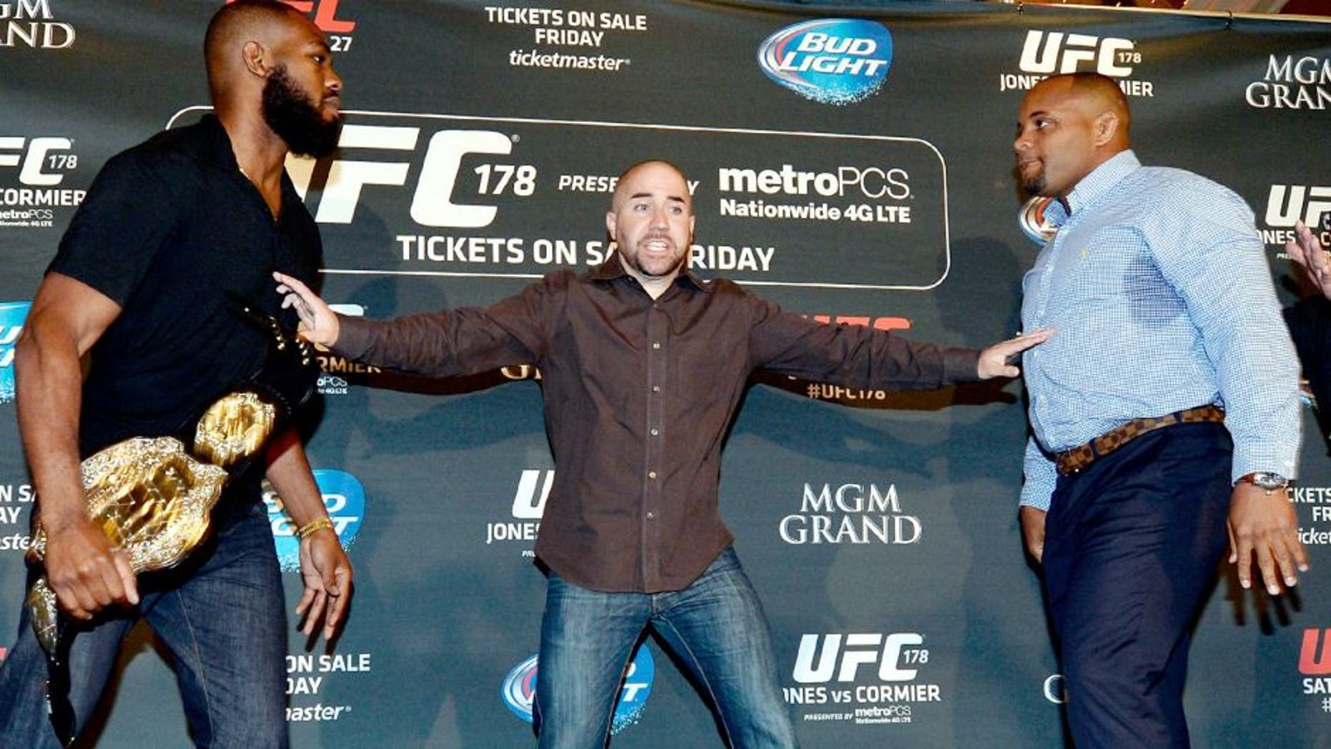 UFC light heavyweight champion Jon Jones and challenger Daniel Cormier are separated after facing off during the UFC 178 Ultimate Media Day at the MGM Grand Hotel/Casino on August 4, 2014 in Las Vegas, Nevada. (Photo by Jeff Bottari/Zuffa LLC/Zuffa LLC via Getty Images)
