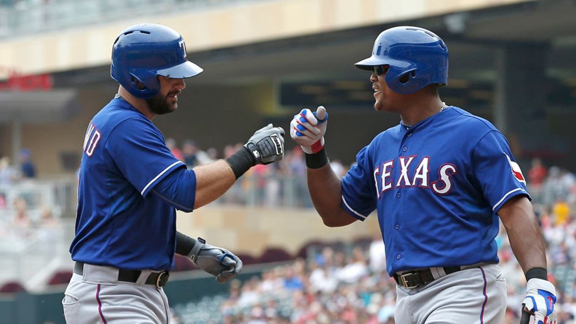 Texas Rangersâ Mitch Moreland, left, is congratulated by Adrian Beltre following his two-run home run off Minnesota Twins pitcher Ervin Santana in the fourth inning of a baseball game, Thursday, Aug. 13, 2015, in Minneapolis. (AP Photo/Jim Mone)
