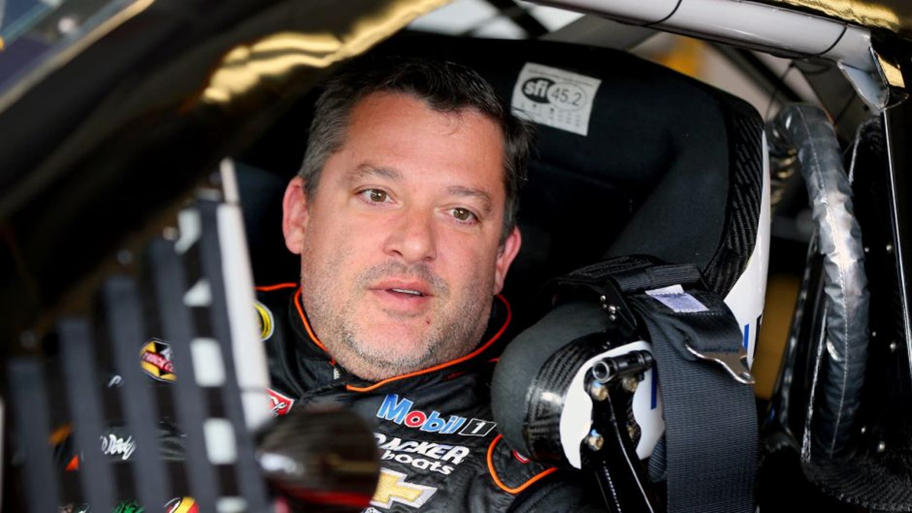 WATKINS GLEN, NY - AUGUST 07: Tony Stewart, driver of the #14 Bass Pro Shops/Mobil 1 Chevrolet, sits in his car in the garage area during practice for the NASCAR Sprint Cup Series Cheez-It 355 at Watkins Glen International on August 7, 2015 in Watkins Glen, New York. (Photo by Matt Sullivan/Getty Images)