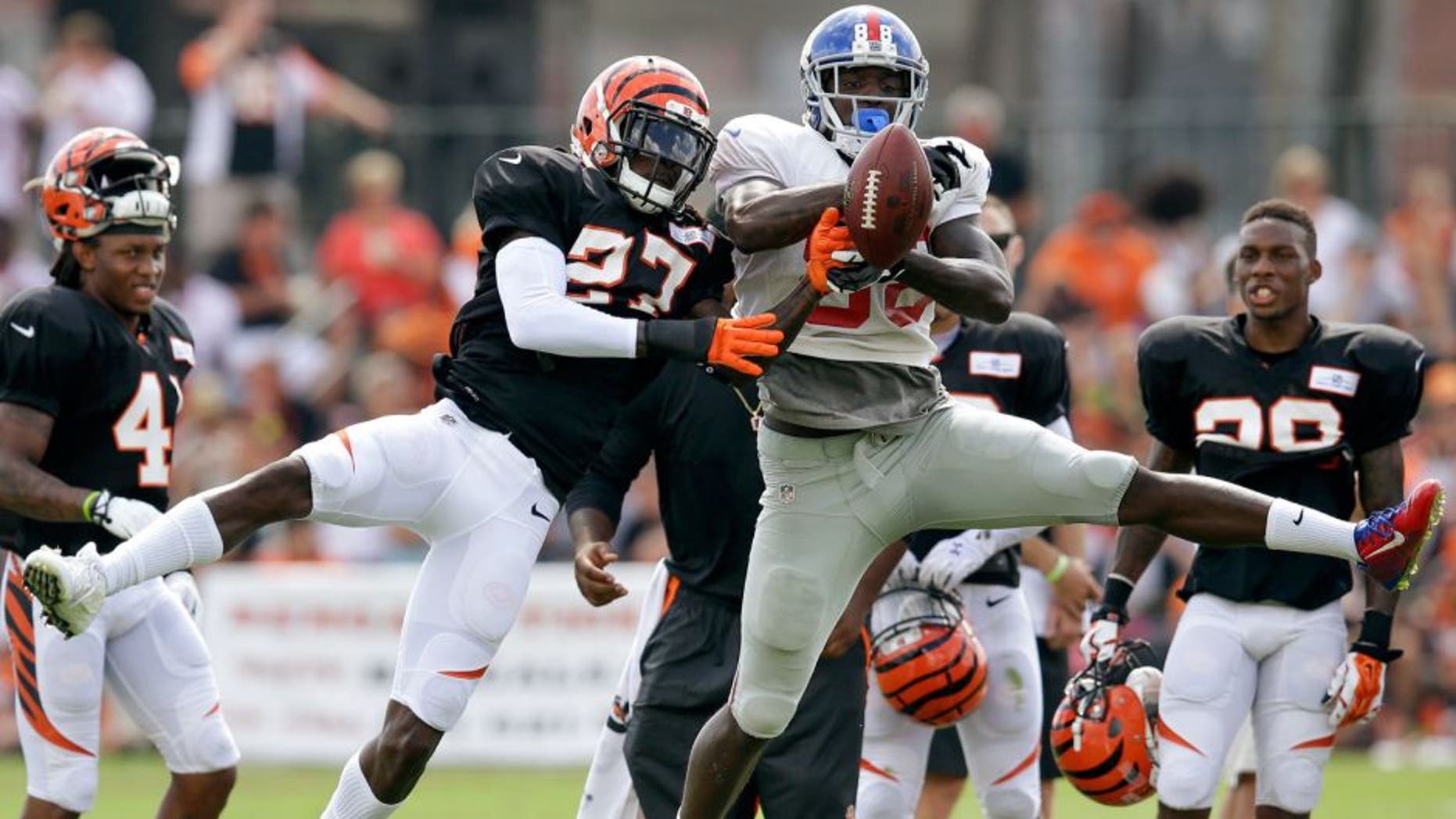 Cincinnati Bengals cornerback Dre Kirkpatrick (27) blocks a pass to New York Giants wide receiver Corey Washinton during NFL football training camp, Tuesday, Aug. 11, 2015, in Cincinnati. (AP Photo/John Minchillo)