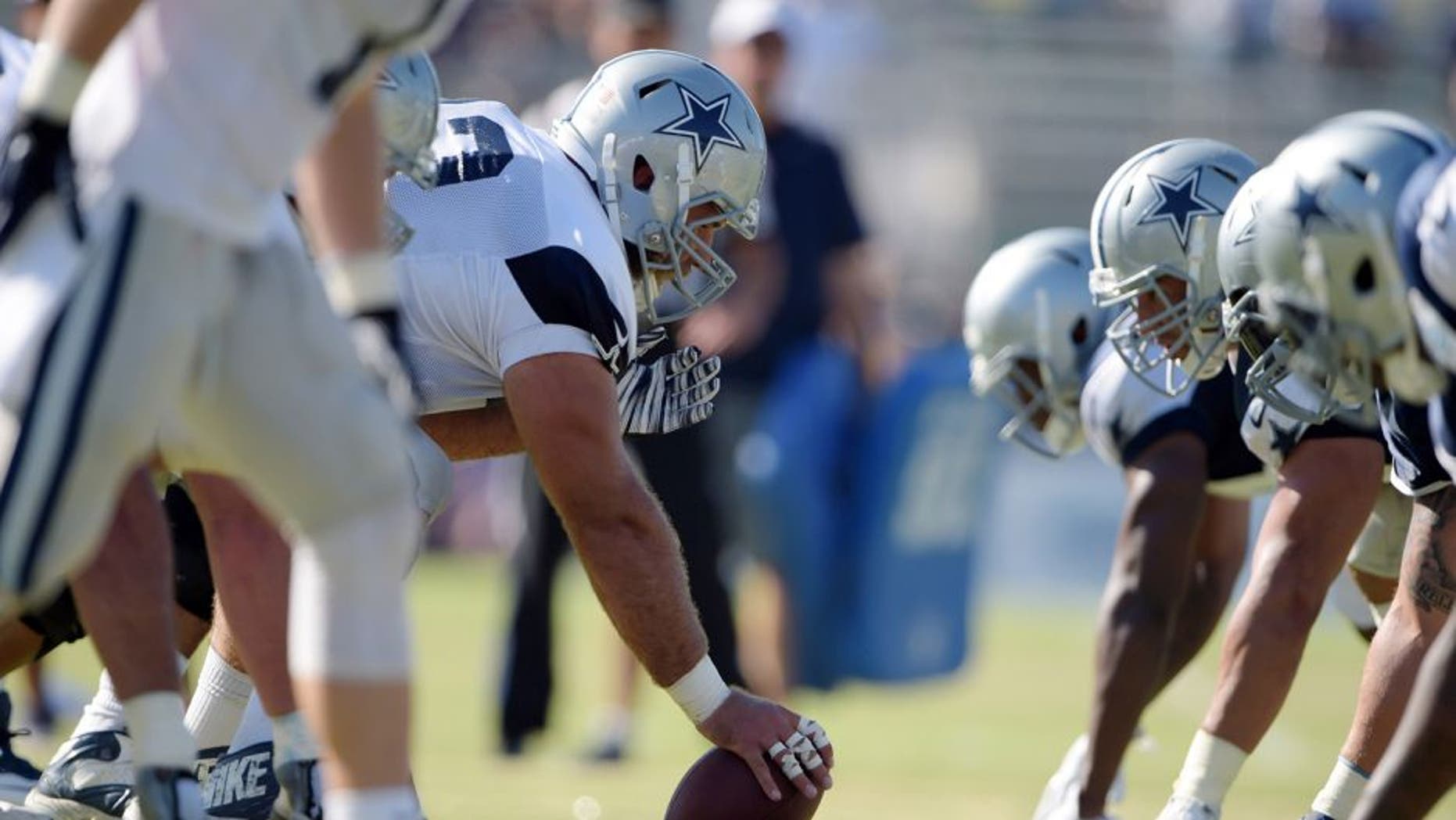 Aug 1, 2015; Oxnard, CA, USA; General view of the line of scrimmage as Dallas Cowboys center Shane McDermott (62) snaps the ball at training camp at River Ridge Fields. Mandatory Credit: Kirby Lee-USA TODAY Sports