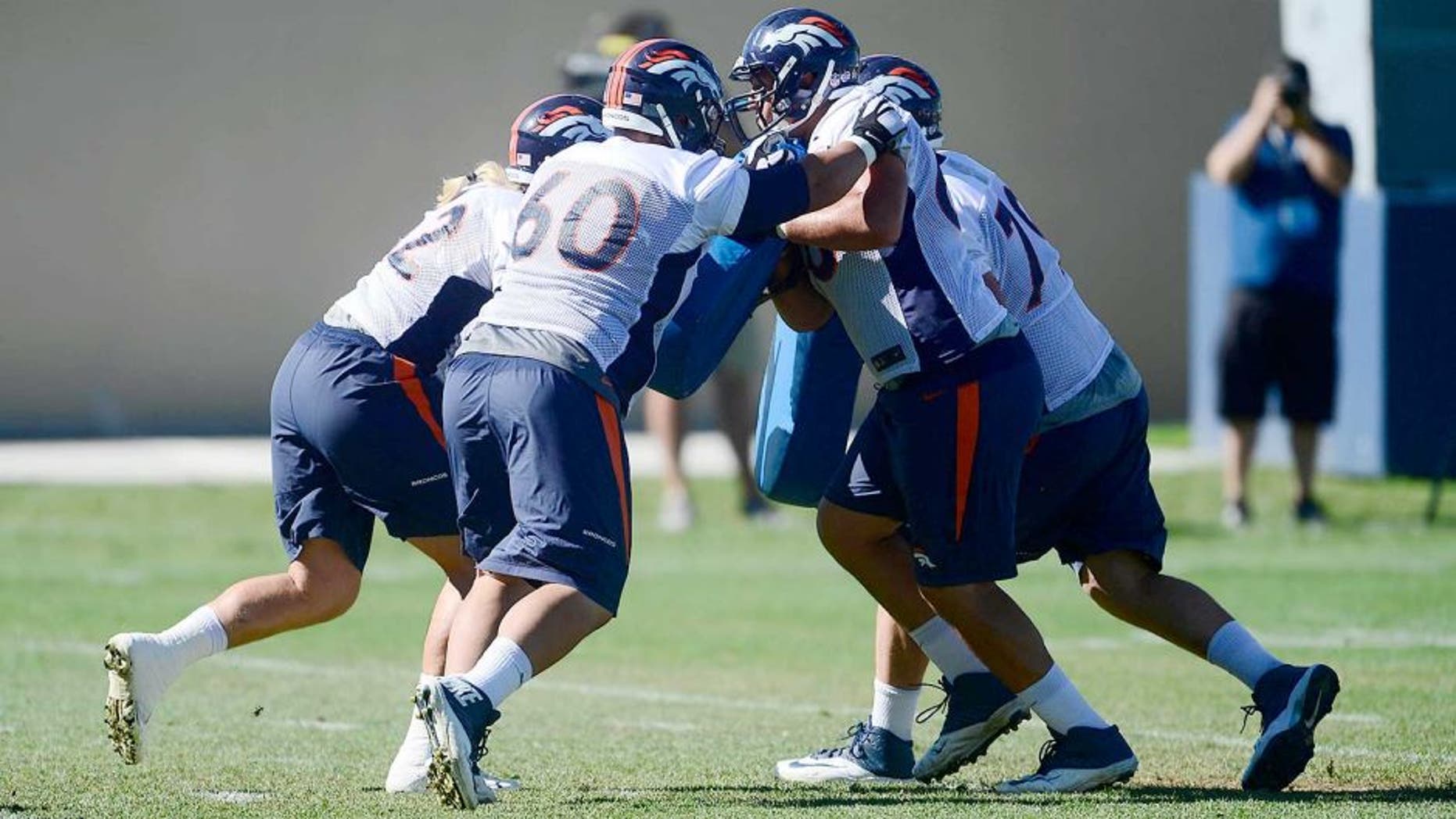 Aug 12, 2015; Englewood, CO, USA; Denver Broncos center Dillon Day (62), guard Andre Davis (60), tackle Louis Vasquez (65) and tackle Michael Schofield (79) pad train during training camp activities at the UCHealth Training Center. Mandatory Credit: Ron Chenoy-USA TODAY Sports