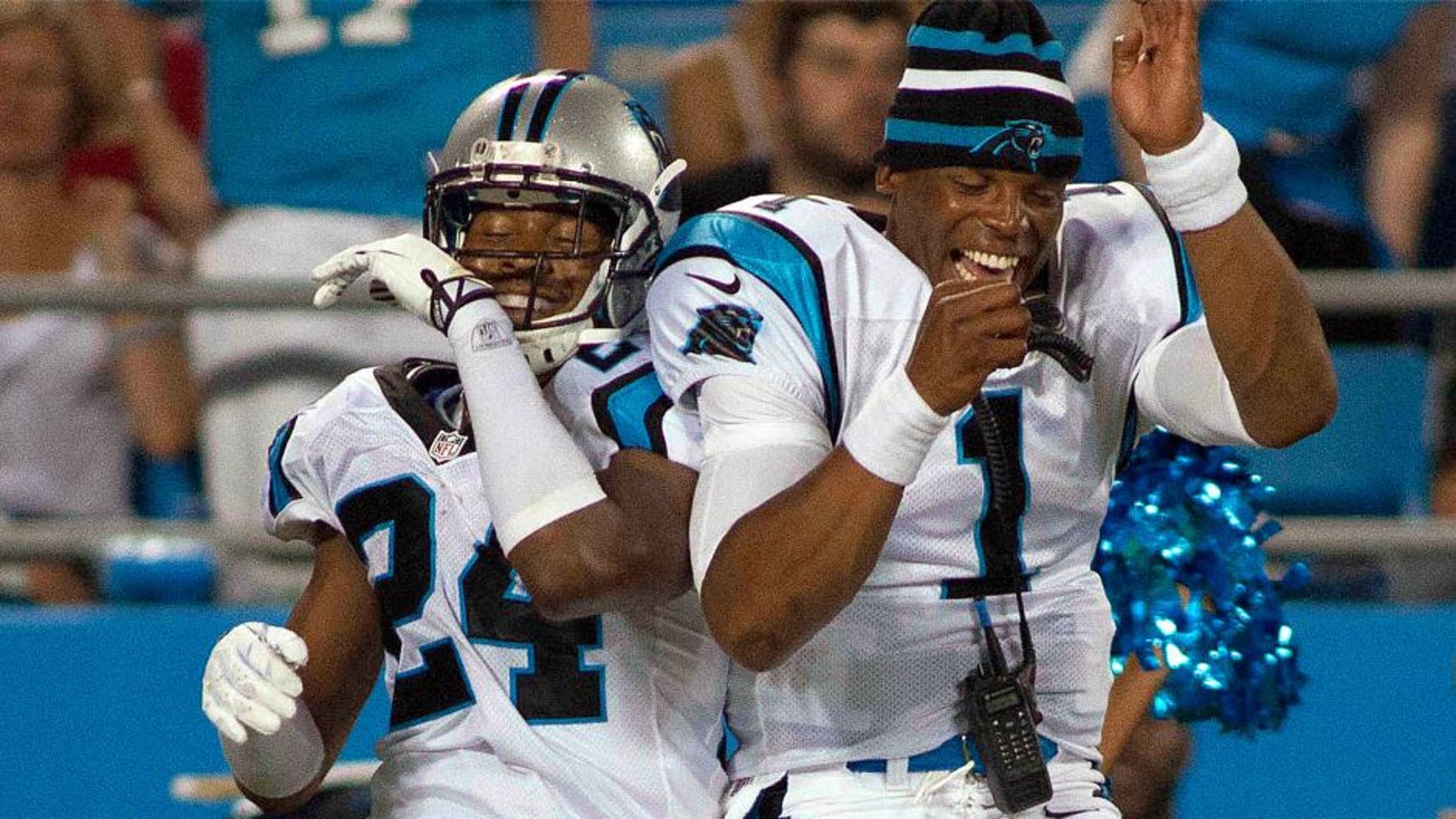 Aug 9, 2013; Charlotte, NC, USA; Carolina Panthers quarterback Cam Newton (1) celebrates with cornerback Josh Norman (24) after scoring a touchdown during the second half against the Chicago Bears. The Panthers defeated the Bears 24-17. Mandatory Credit: Jeremy Brevard-USA TODAY Sports
