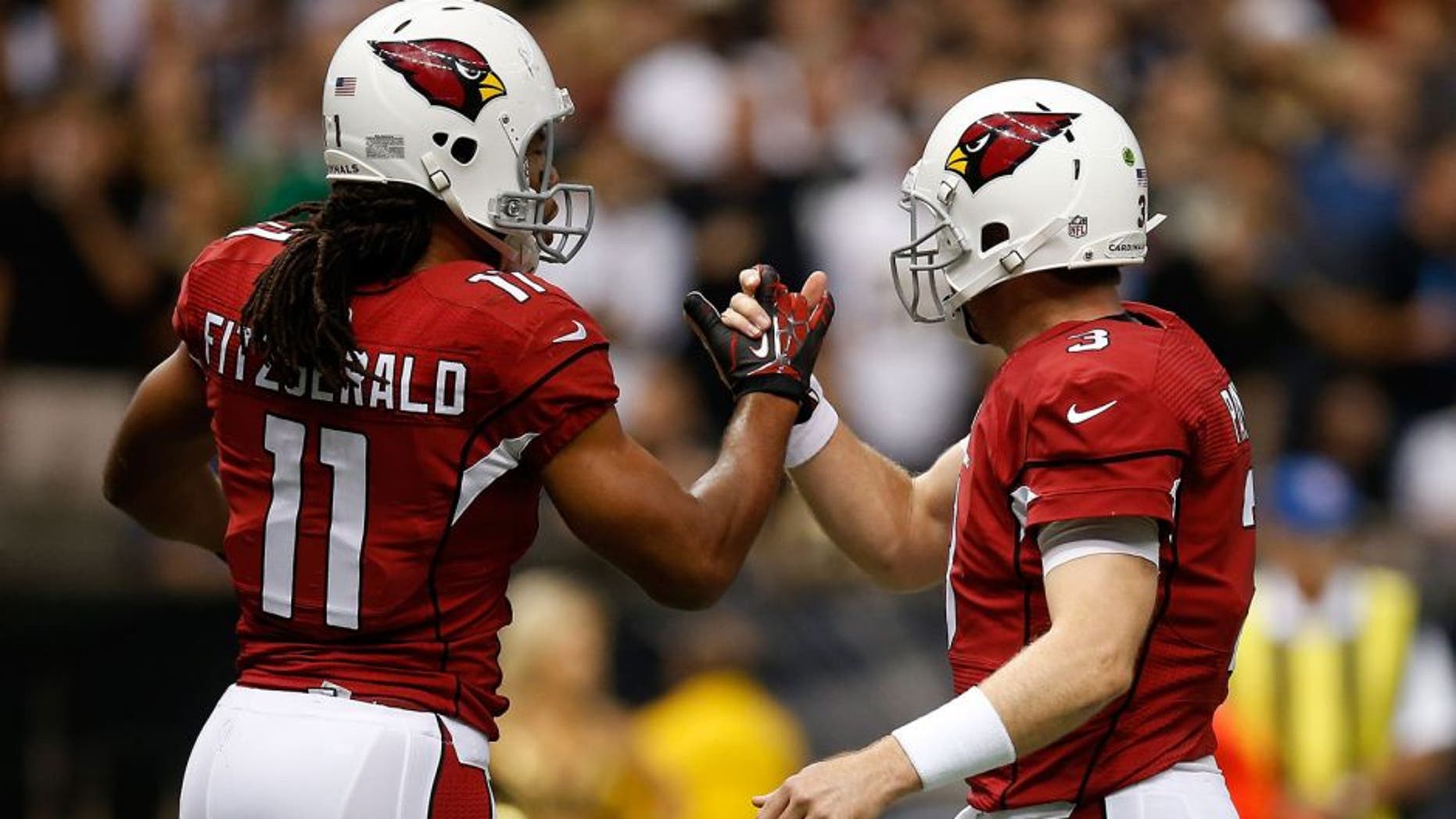 NEW ORLEANS, LA - SEPTEMBER 22: Carson Palmer and Larry Fitzgerald #11 of the Arizona Cardinals celebrate after a touchdown against the New Orleans Saints at the Mercedes-Benz Superdome on September 22, 2013 in New Orleans, Louisiana. (Photo by Chris Graythen/Getty Images)