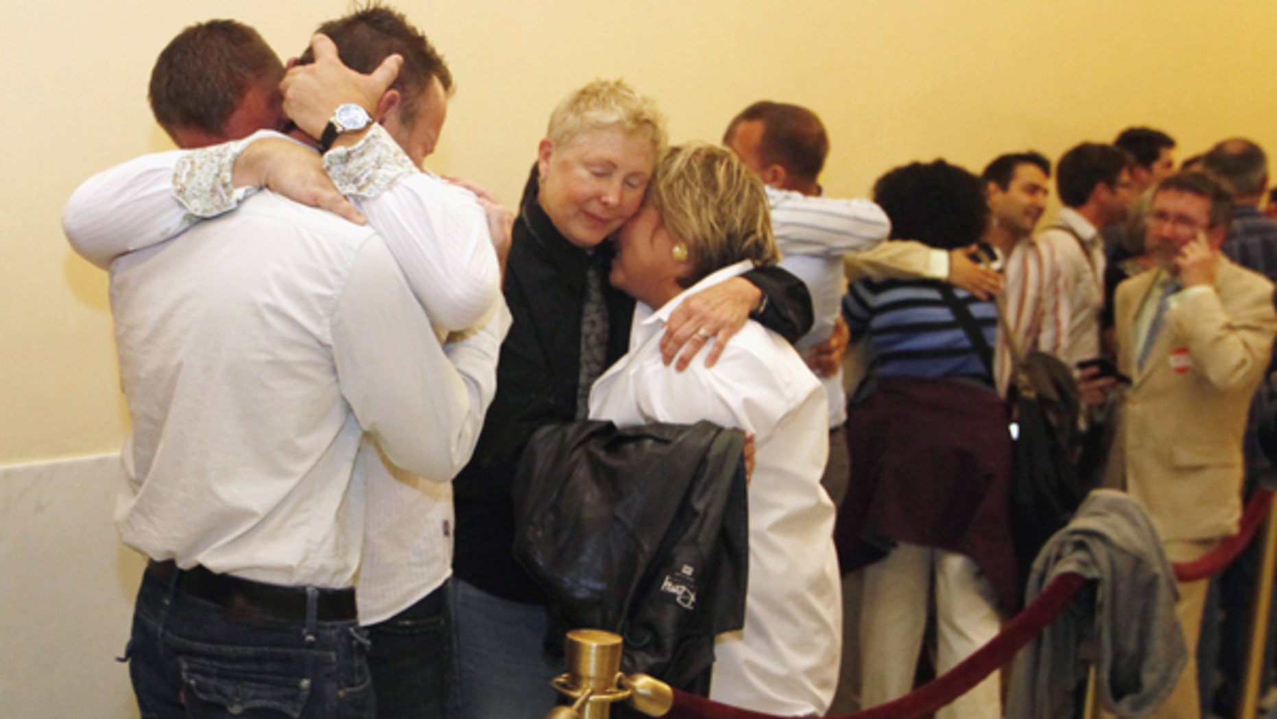 Aug. 12: Same-sex couples waiting in line to be married react to the news that they may not marry for at least another week in San Francisco.