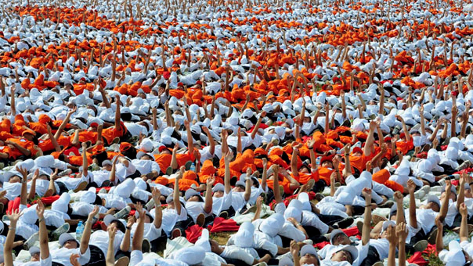 Aug. 12: In an attempt to enter the Guinness Book of World Records, 10,267 people acted as human dominoes, tumbling in less than two hours in Ordos, Inner Mongolia.