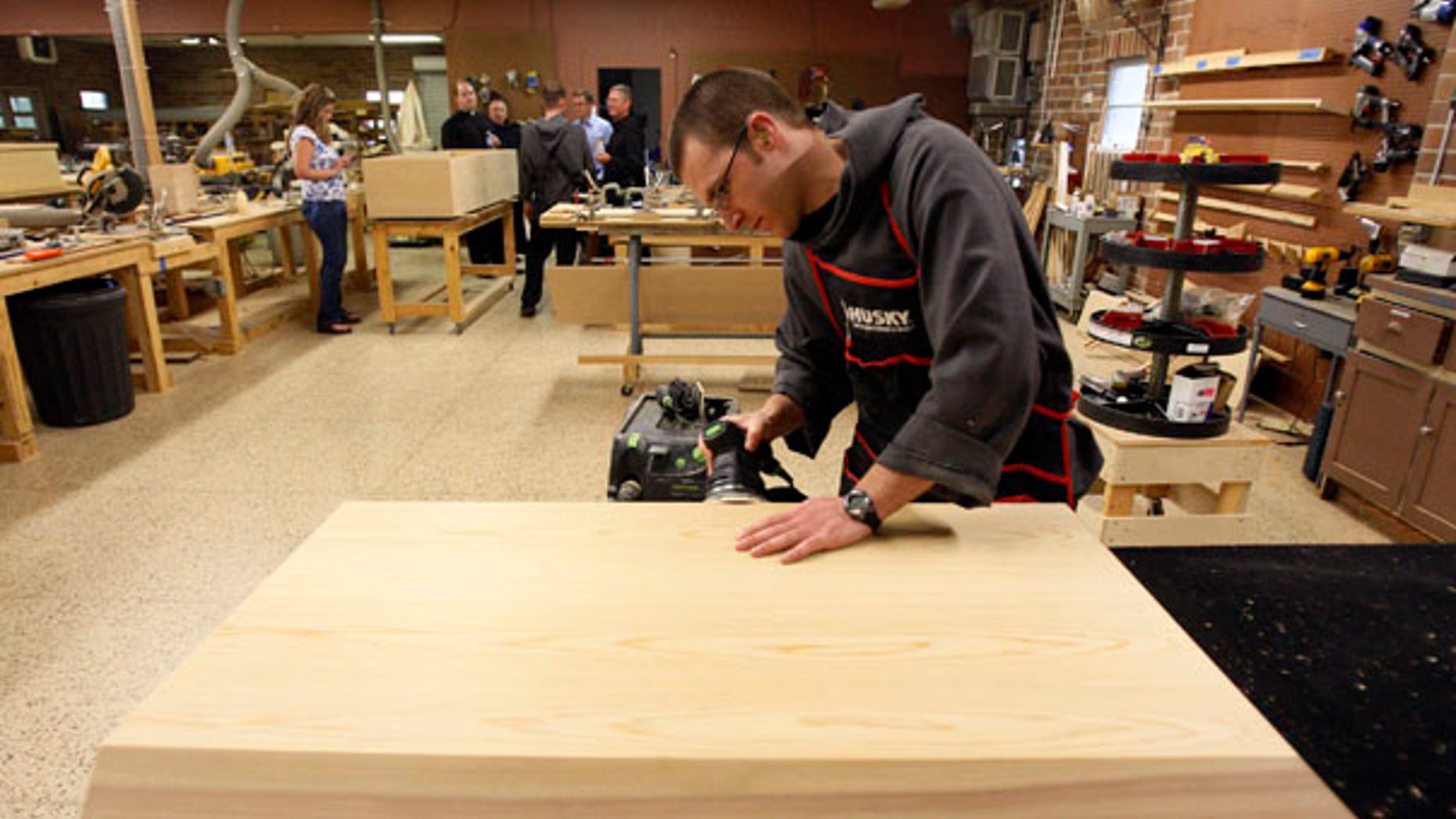 Aug. 12: Benedictine Novice Joseph Eichorn sands a casket lid in a workshop at St. Joseph Abbey in Covington, La.