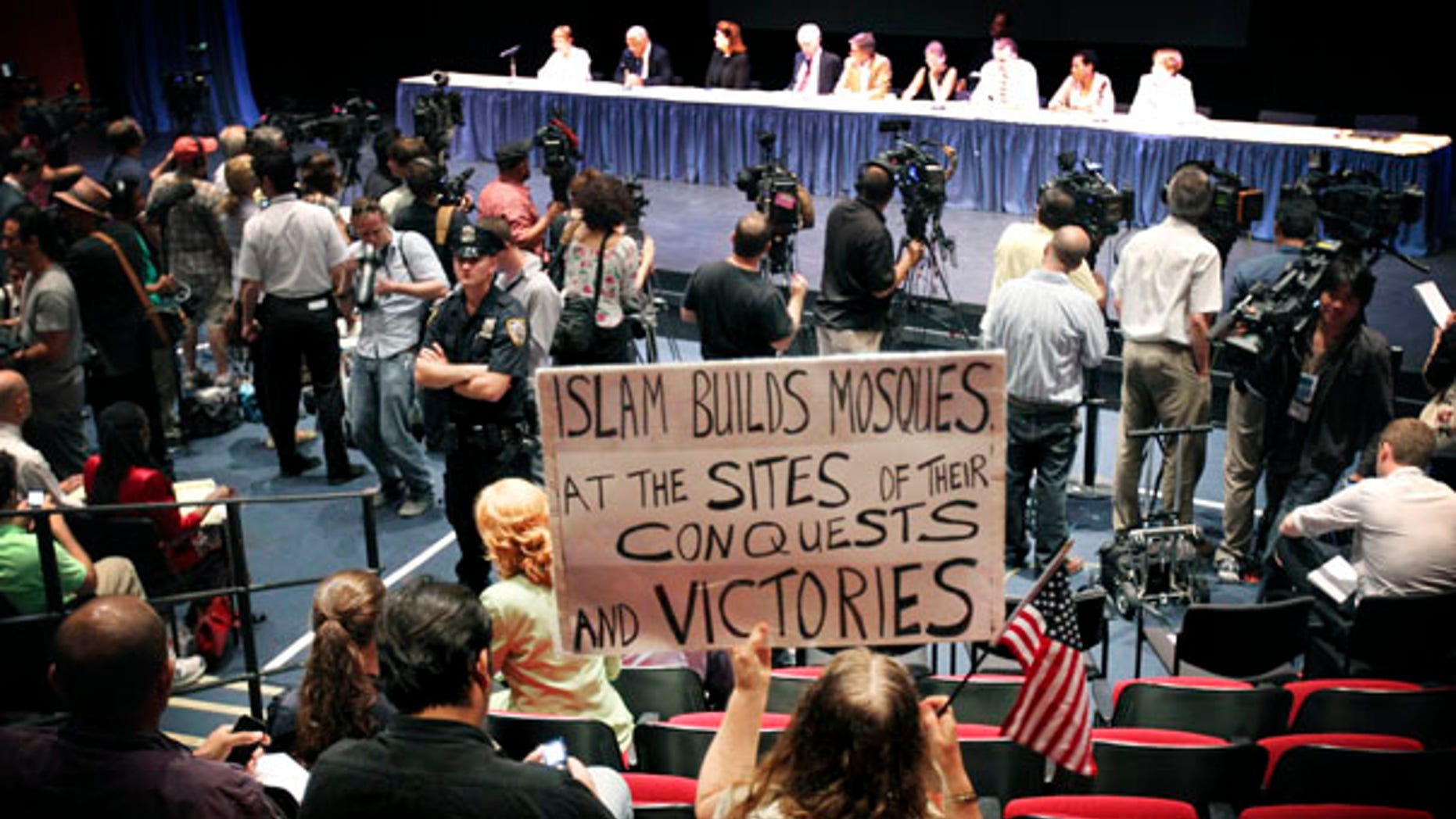 Aug. 3: A protester holds up a sign opposing the construction of a mosque and Islamic center near New York's ground zero during a hearing of the Landmarks Preservation Commission.