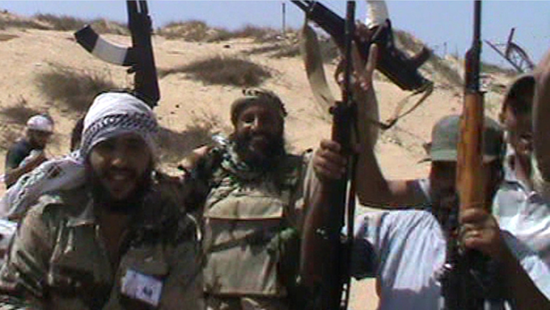 Aug. 12: In this image made from amateur video and accessed by The Associated Press, rebel soldiers celebrate in Brega, Libya.
