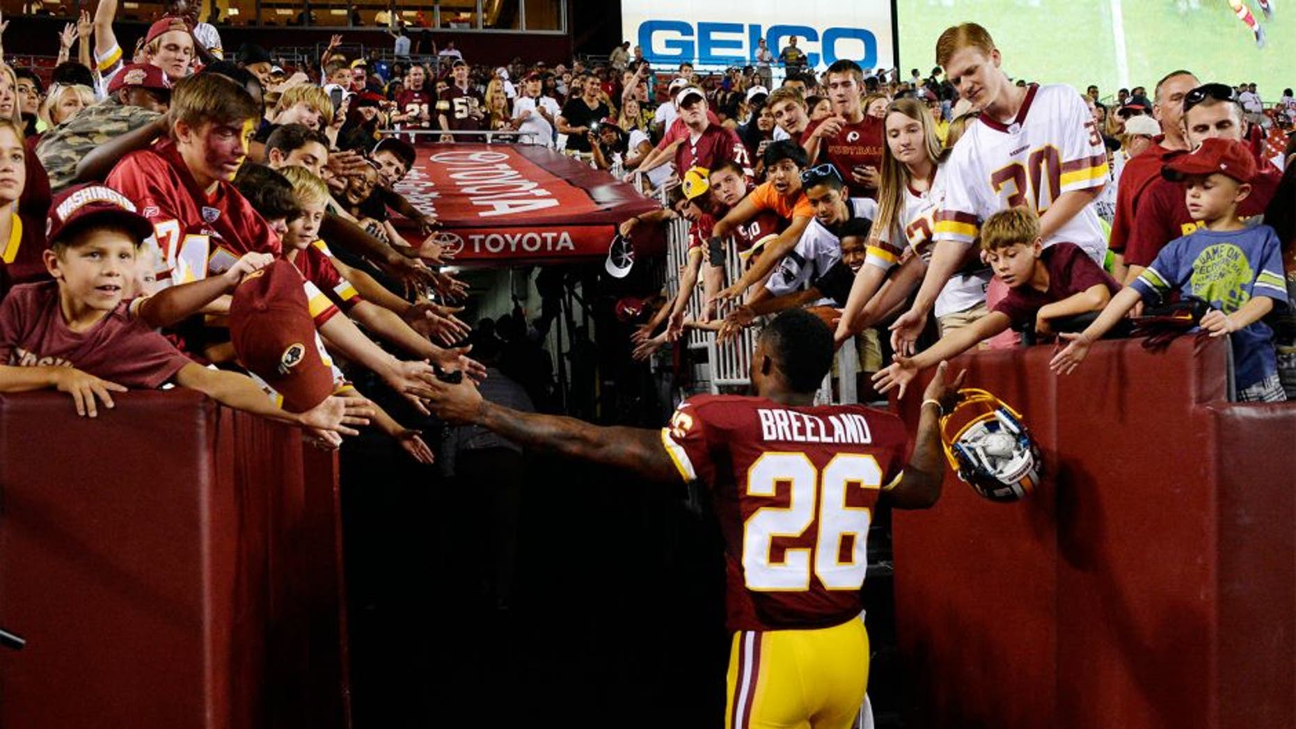 Aug 7, 2014; Landover, MD, USA; Washington Redskins cornerback Bashaud Breeland (26) greets fans after the game against the New England Patriots at FedEx Field. The Redskins won 23-6. Mandatory Credit: Rafael Suanes-USA TODAY Sports