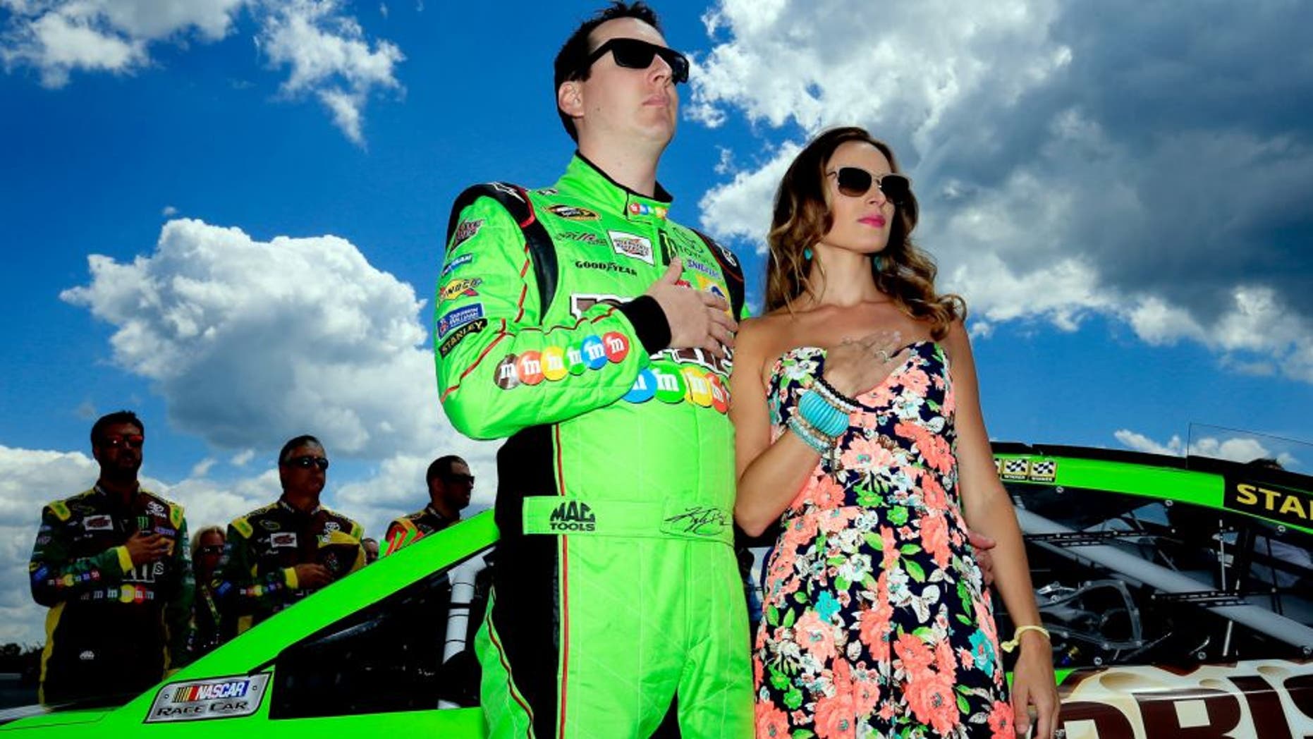 LONG POND, PA - AUGUST 02: Kyle Busch, driver of the #18 M&M's Crispy Toyota, stands with his wife Samantha prior to the NASCAR Sprint Cup Series Windows 10 400 at Pocono Raceway on August 2, 2015 in Long Pond, Pennsylvania. (Photo by Chris Trotman/Getty Images)