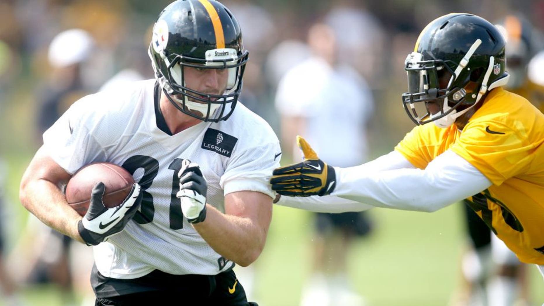 Jul 27, 2015; Latrobe, PA, USA; Pittsburgh Steelers tight end Jesse James (81) runs after a catch as inside linebacker Vince Williams (R) defends during training camp at Saint Vincent College. Mandatory Credit: Charles LeClaire-USA TODAY Sports