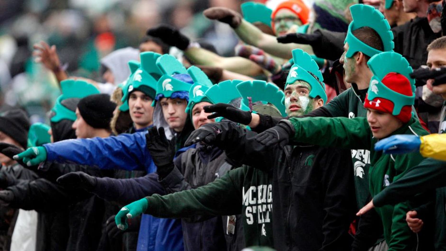 Nov 2, 2013; East Lansing, MI, USA; Michigan State Spartans fans cheer during the first quarter against the Michigan Wolverines at Spartan Stadium. Mandatory Credit: Raj Mehta-USA TODAY Sports