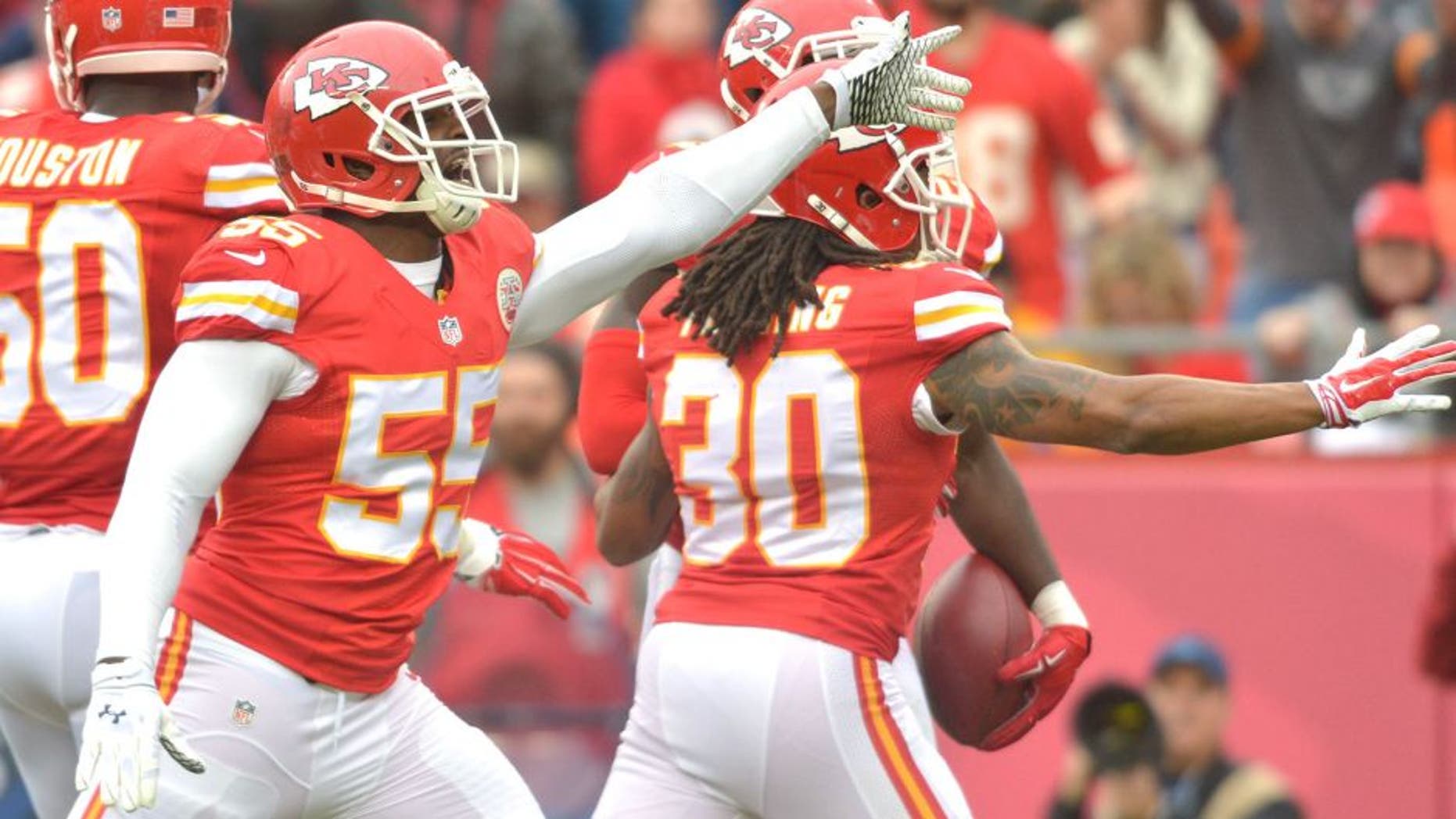 Dec 14, 2014; Kansas City, MO, USA; Kansas City Chiefs linebacker Dee Ford (55) and outside linebacker Justin Houston (50) celebrate after a play during the first half against the Oakland Raiders at Arrowhead Stadium. The Chiefs won 31-13. Mandatory Credit: Denny Medley-USA TODAY Sports