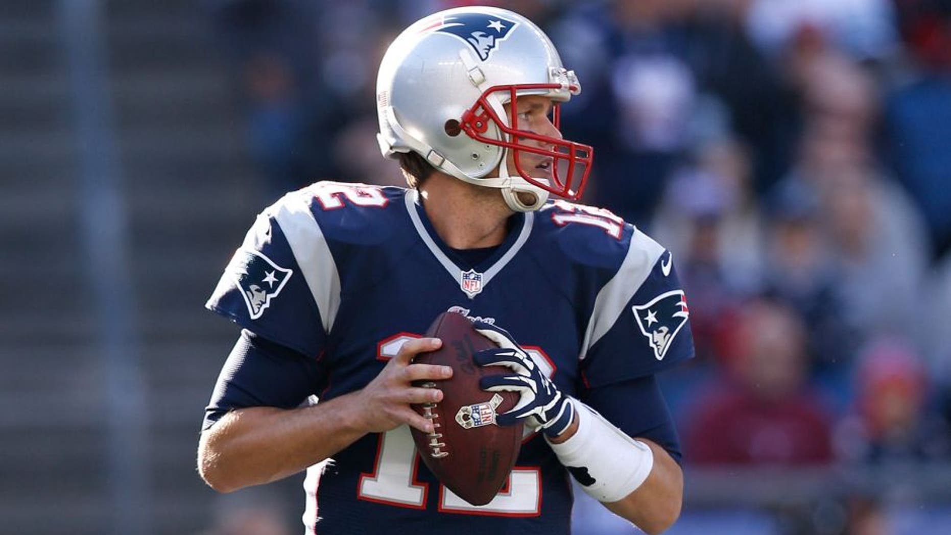 Nov 23, 2014; Foxborough, MA, USA; New England Patriots quarterback Tom Brady (12) drops back to make a pass during the first quarter against the Detroit Lions at Gillette Stadium. Mandatory Credit: Greg M. Cooper-USA TODAY Sports