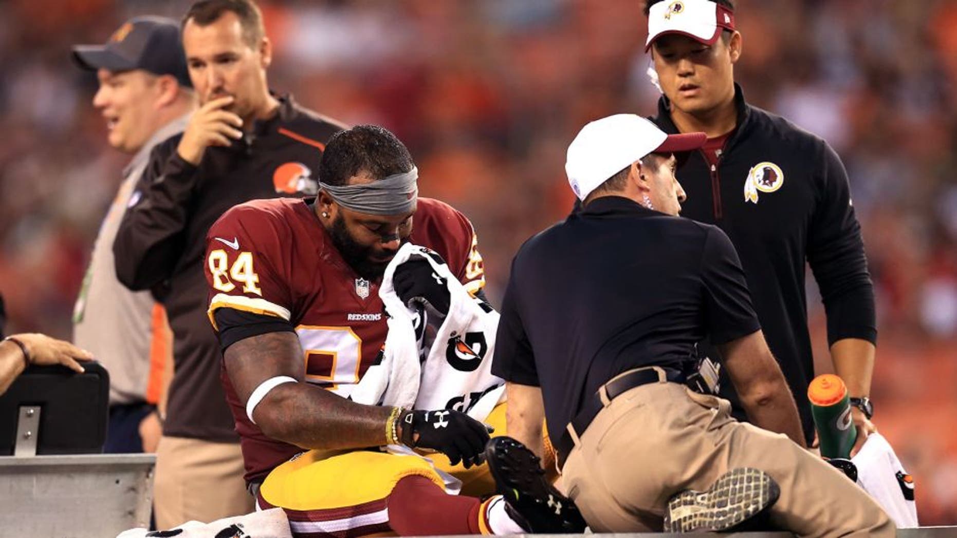 Aug 13, 2015; Cleveland, OH, USA; Washington Redskins tight end Niles Paul (84) is carted off the field after an injury during the first quarter of preseason NFL football game against the Cleveland Browns at FirstEnergy Stadium. Mandatory Credit: Andrew Weber-USA TODAY Sports
