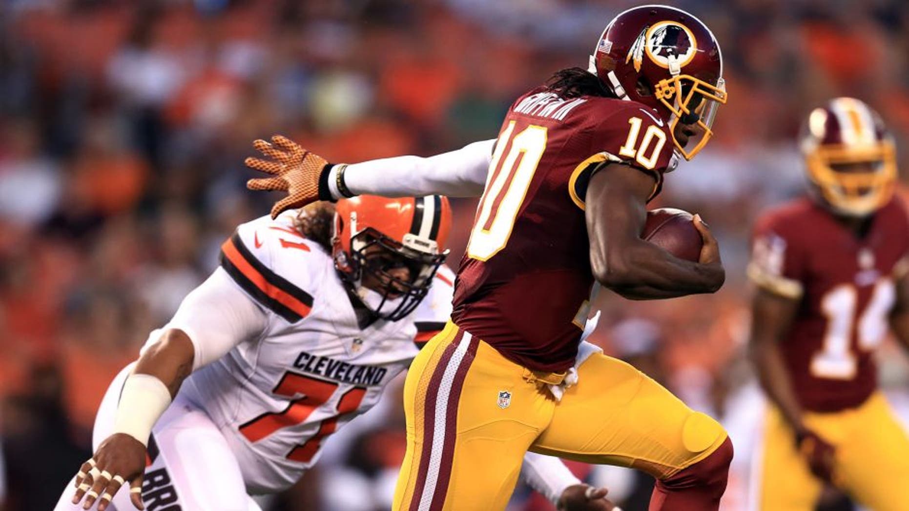 Aug 13, 2015; Cleveland, OH, USA; Washington Redskins quarterback Robert Griffin III (10) runs the ball during the first quarter of preseason NFL football game against the Cleveland Browns at FirstEnergy Stadium. Mandatory Credit: Andrew Weber-USA TODAY Sports