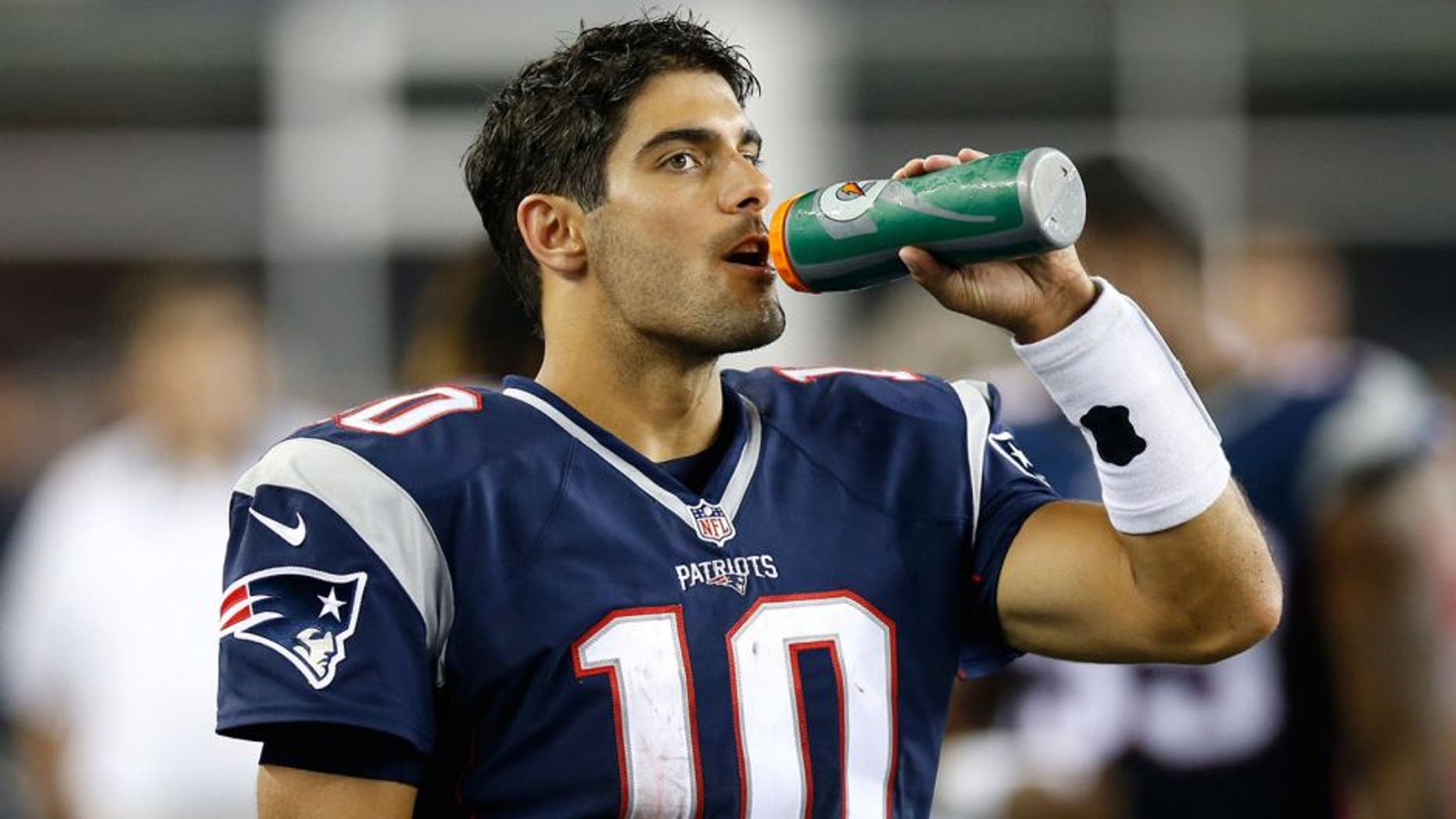 Aug 13, 2015; Foxborough, MA, USA; New England Patriots quarterback Jimmy Garoppolo (10) drinks some water on the side line during the third quarter against the Green Bay Packers at Gillette Stadium. The Green Bay Packers won 22-11. Mandatory Credit: Greg M. Cooper-USA TODAY Sports