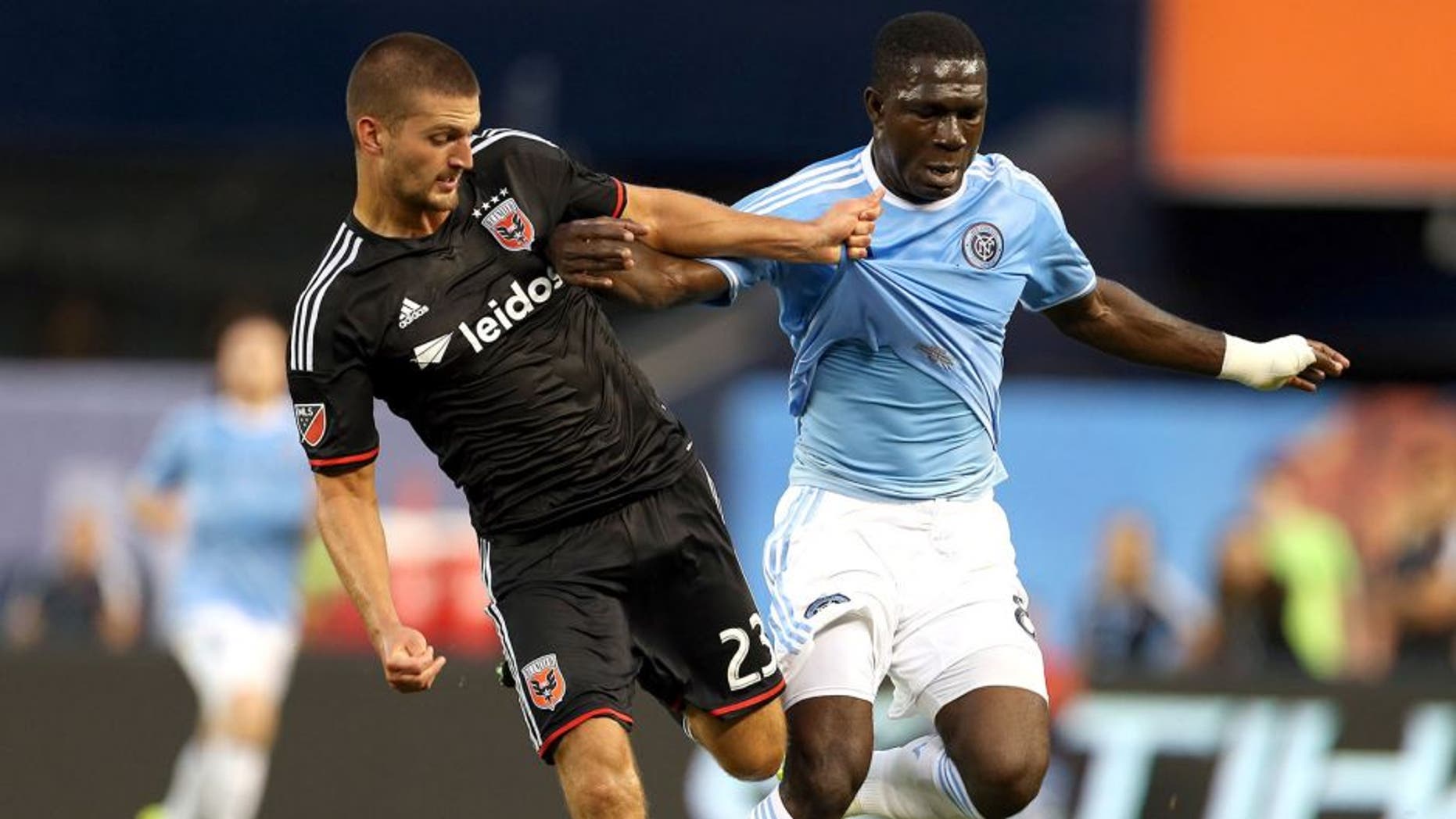 Aug 13, 2015; New York, NY, USA; New York City FC midfielder Kwadwo Poku (88) battles for the ball with D.C. United midfielder Perry Kitchen (23) during the first half of their soccer match at Yankee Stadium. Mandatory Credit: Adam Hunger-USA TODAY Sports