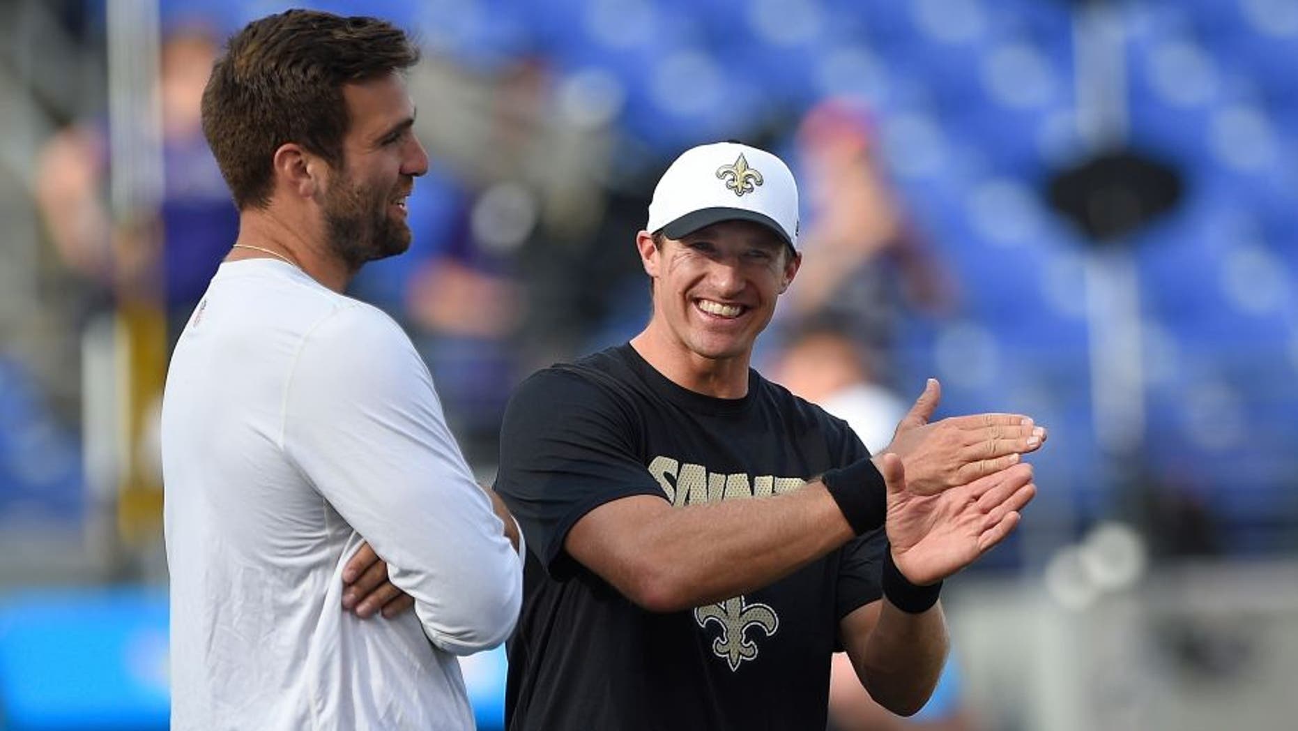 Baltimore Ravens quarterback Joe Flacco, left, talks with New Orleans Saints quarterback Drew Brees before an NFL preseason football game in Baltimore, Thursday, Aug. 13, 2015. (AP Photo/Nick Wass)