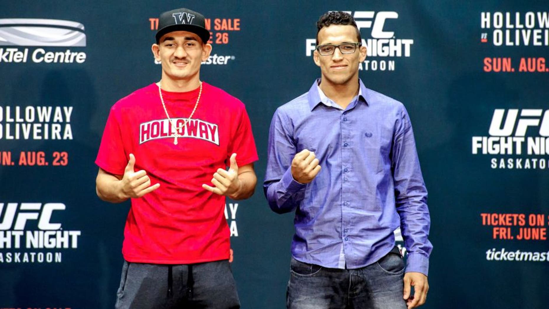 SASKATOON, SK - JUNE 24: Max Holloway (L) and Charles Oliveira (R) square off for the crowd at a press conference at the SaskTel Centre, June 24, 2015 in Saskatoon, Saskatchewan, Canada. (Photo by Steve Hiscock/Getty images)