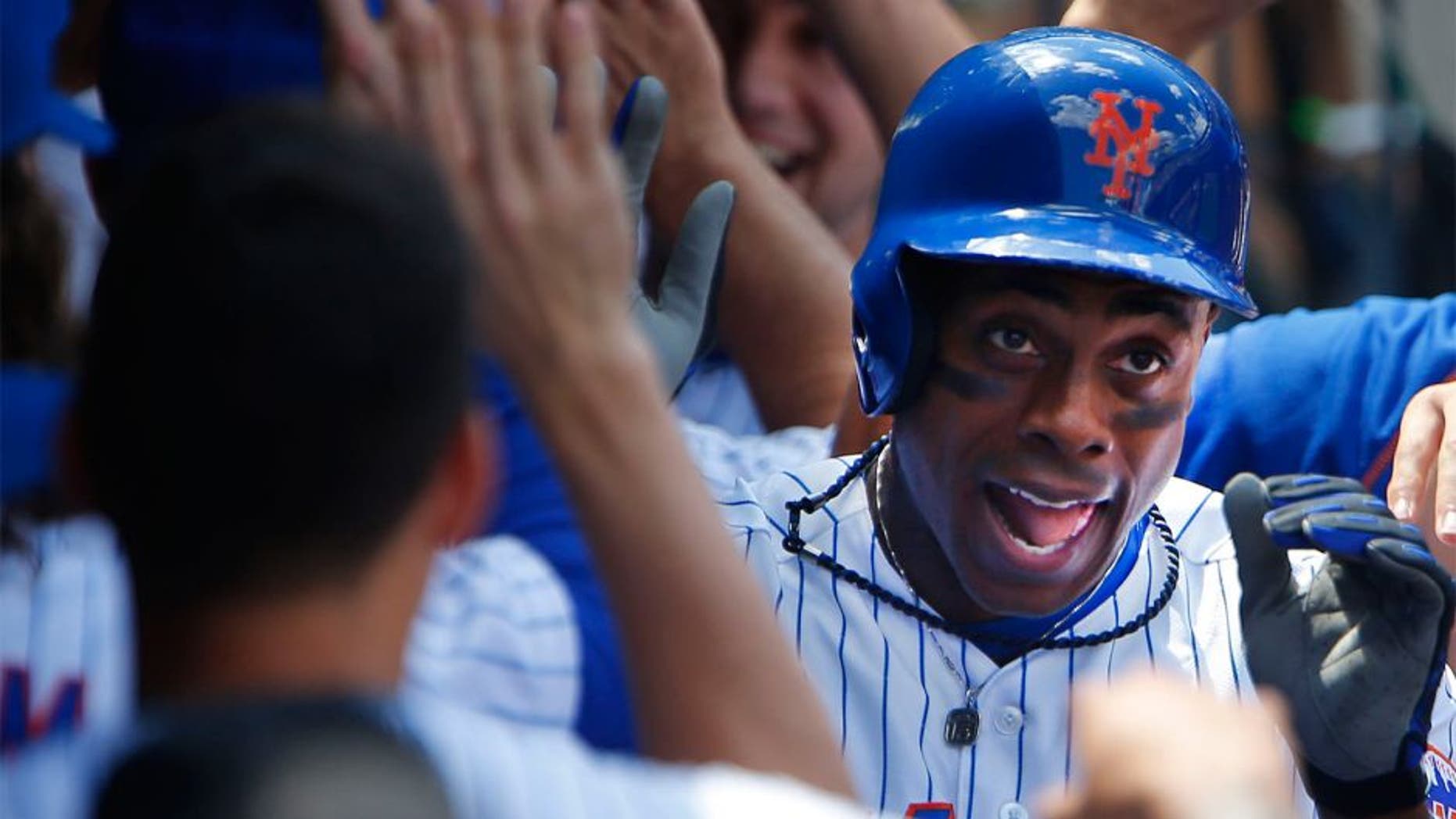 Aug 13, 2015; New York City, NY, USA; New York Mets right fielder Curtis Granderson (3) is congratulated in the dugout by teammates after his two run home run in the fourth inning against the Colorado Rockies at Citi Field. Mandatory Credit: Noah K. Murray-USA TODAY Sports