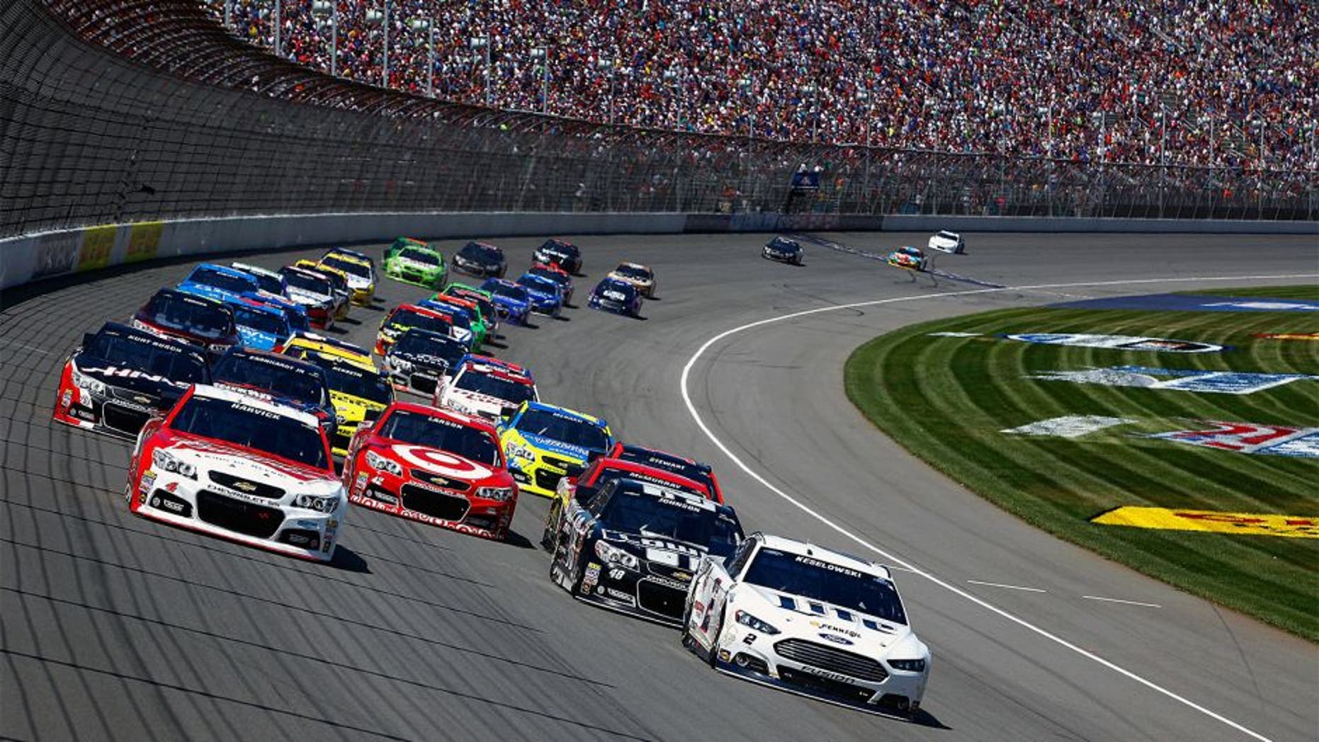 BROOKLYN, MI - JUNE 15: Kevin Harvick, driver of the #4 Budweiser Chevrolet, and Brad Keselowski, driver of the #2 Miller Lite Ford, lead the field on a restart during the NASCAR Sprint Cup Series Quicken Loans 400 at Michigan International Speedway on June 15, 2014 in Brooklyn, Michigan. (Photo by Brian Lawdermilk/NASCAR via Getty Images)