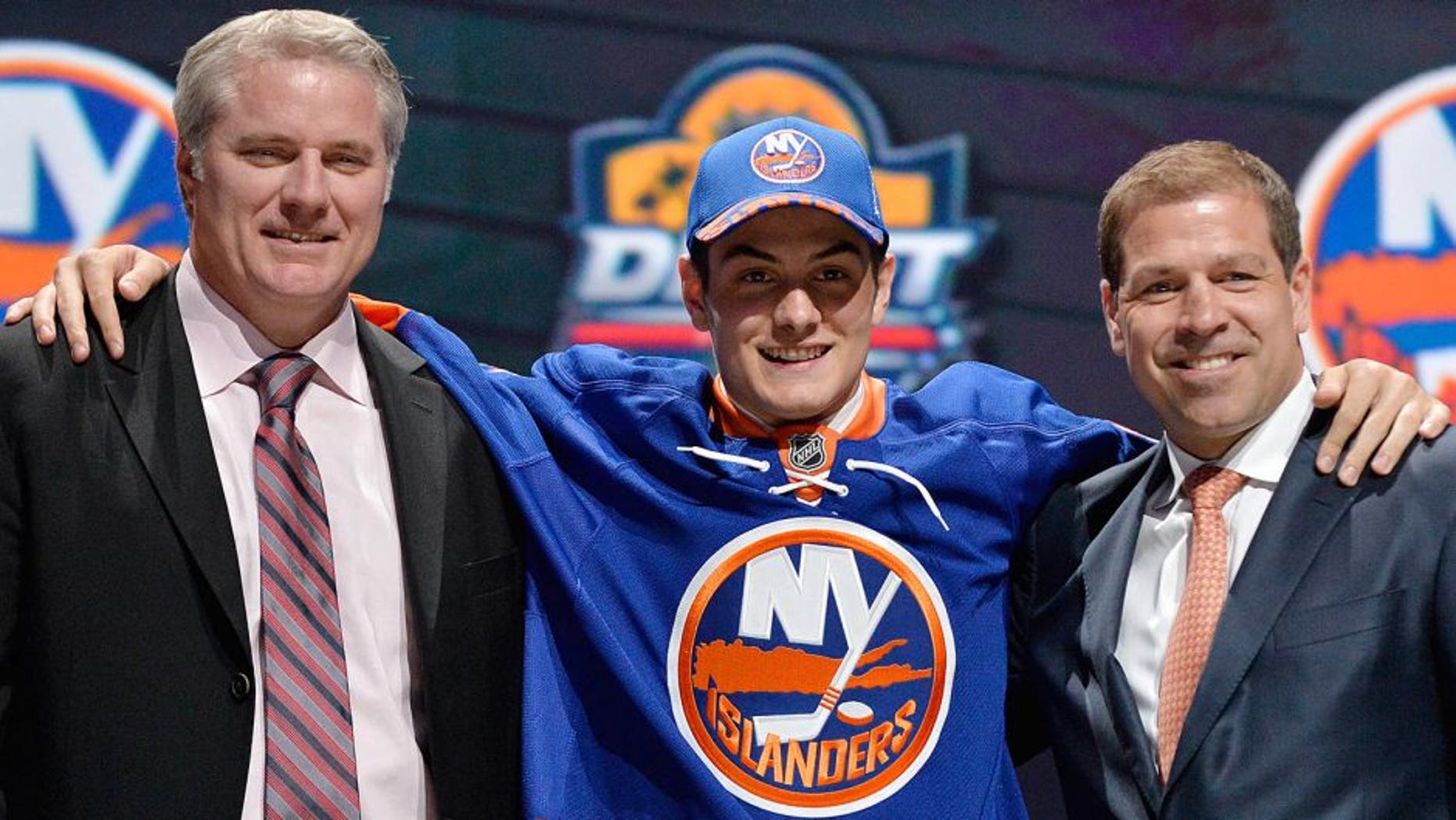 Jun 26, 2015; Sunrise, FL, USA; Mathew Barzal poses with team executives after being selected as the number sixteen overall pick to the New York Islanders in the first round of the 2015 NHL Draft at BB&T Center. Mandatory Credit: Steve Mitchell-USA TODAY Sports