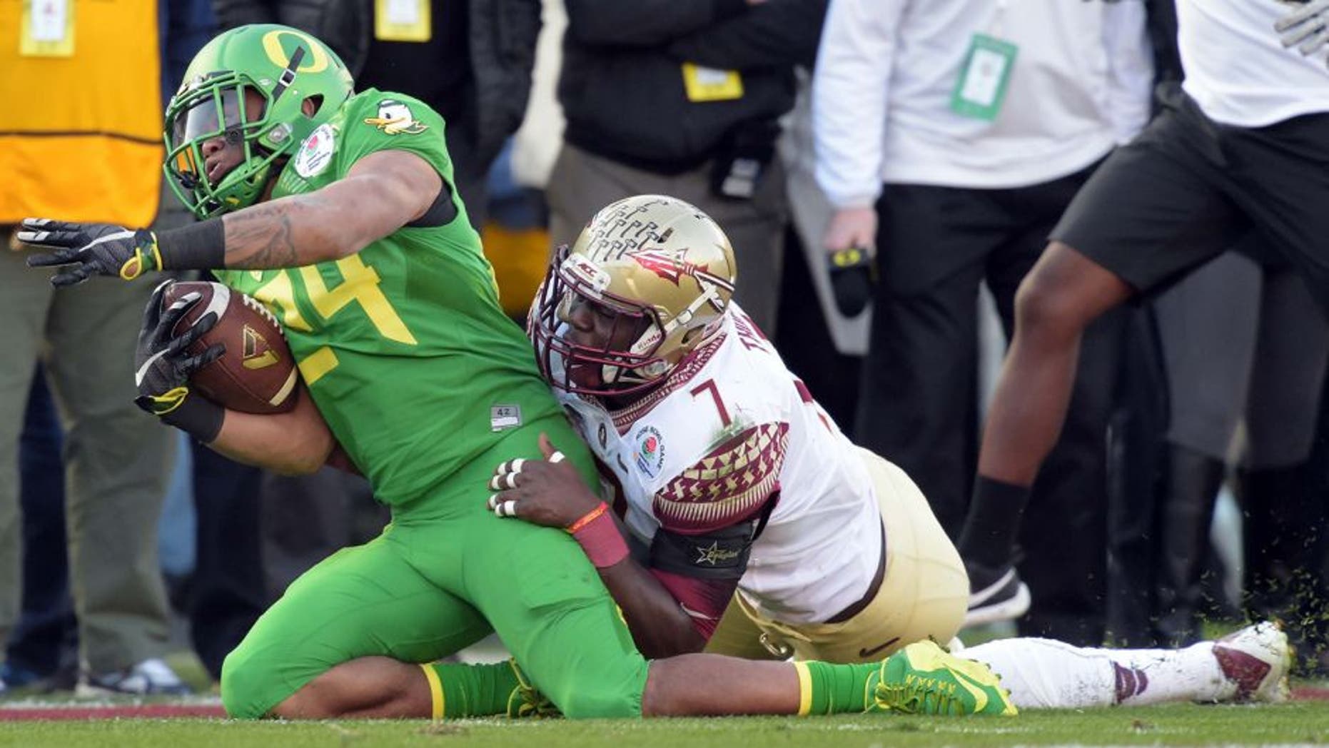 Jan 1, 2015; Pasadena, CA, USA; (EDITORS NOTE: caption correction) Florida State Seminoles linebacker Matthew Thomas (7) tackles Oregon Ducks running back Thomas Tyner (24) in the 2015 Rose Bowl college football game at Rose Bowl. Mandatory Credit: Kirby Lee-USA TODAY Sports