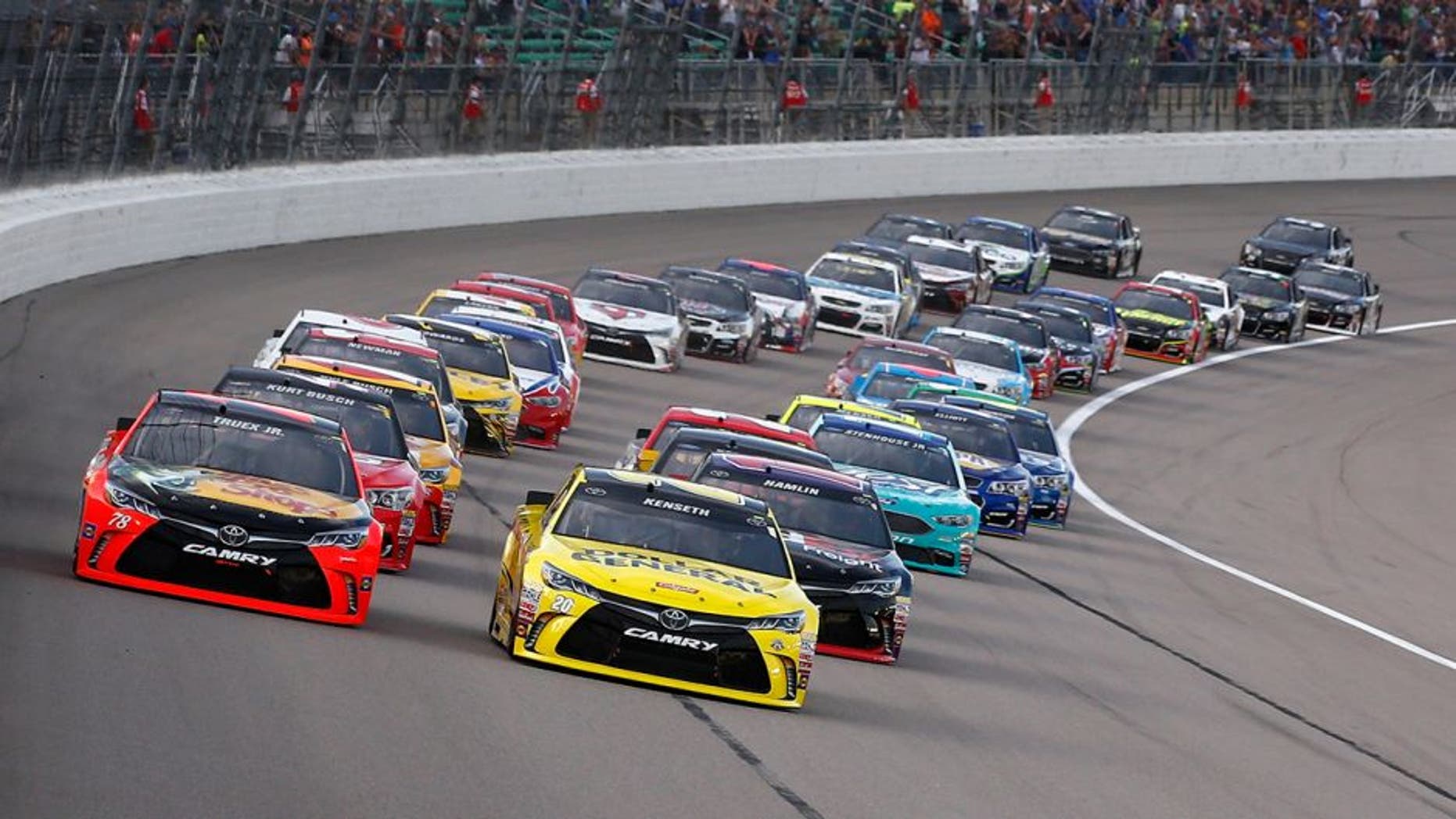 KANSAS CITY, KS - MAY 07: Martin Truex Jr., driver of the #78 Bass Pro Shops/TRACKER Boats Toyota Toyota, and Matt Kenseth, driver of the #20 Dollar General Toyota, lead the field at the start of the NASCAR Sprint Cup Series Go Bowling 400 at Kansas Speedway on May 7, 2016 in Kansas City, Kansas. (Photo by Jamie Squire/Getty Images)