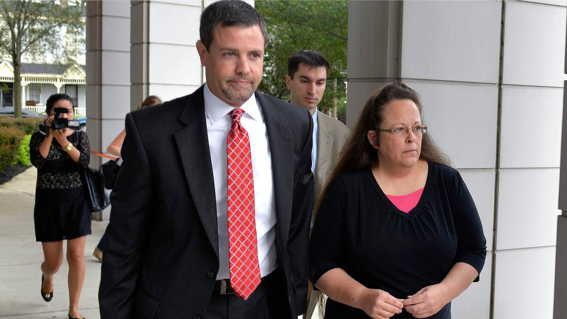 July 20, 2015: Rowan County Clerk Kim Davis, right, walks with her attorney Roger Gannam into the United States District Court for the Eastern District of Kentucky in Covington, Ky.