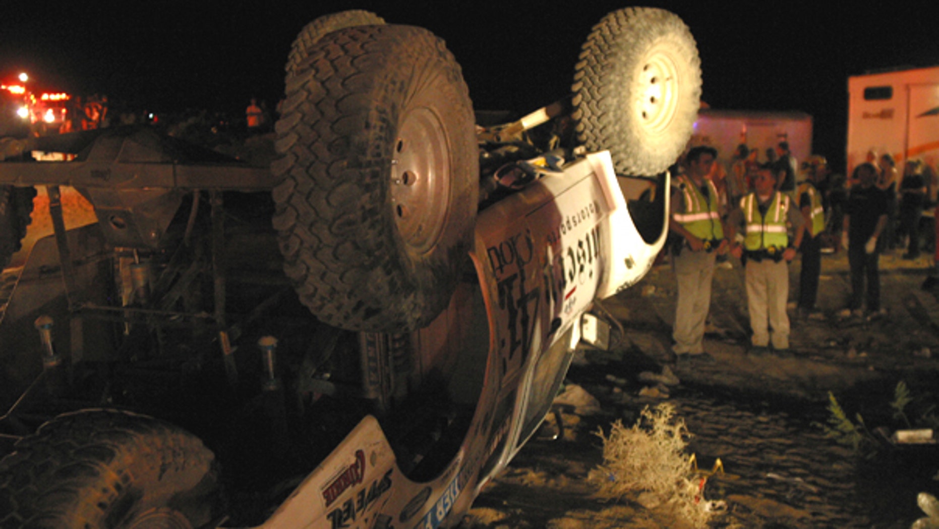 Aug. 14: Emergency workers look at an off-highway vehicle that lost control and barreled into a crowd of spectators at an off-road race called the California 200.