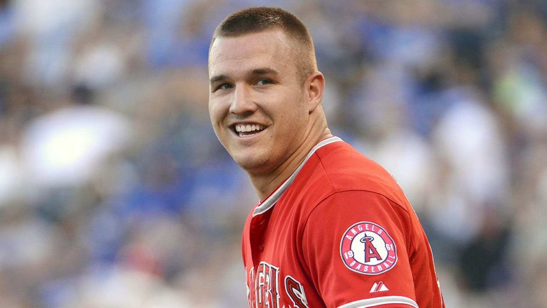 Aug 13, 2015; Kansas City, MO, USA; Los Angeles Angels center fielder Mike Trout (27) walks to the outfield in the first inning against the Kansas City Royals at Kauffman Stadium. Mandatory Credit: John Rieger-USA TODAY Sports